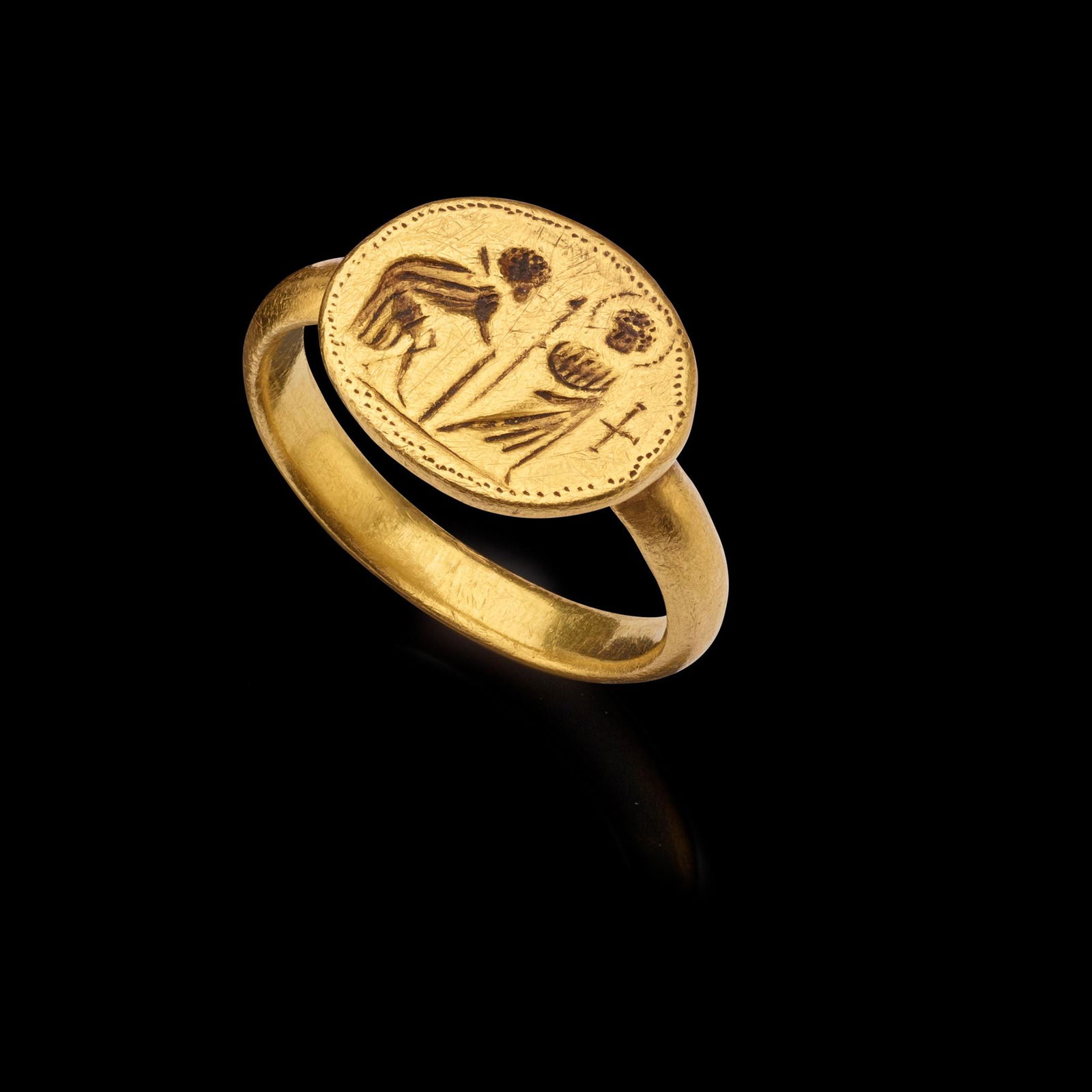 BYZANTINE GOLD FINGER RING EASTERN MEDITERRANEAN, 6TH CENTURY A.D.: cast gold, the face with an engraved scene from the life of Christ, possibly healing the sick, accompanied by a bespoke mount(1.8cm wide, UK ring size K, 7.2gr)Provenance: Private collection, London,