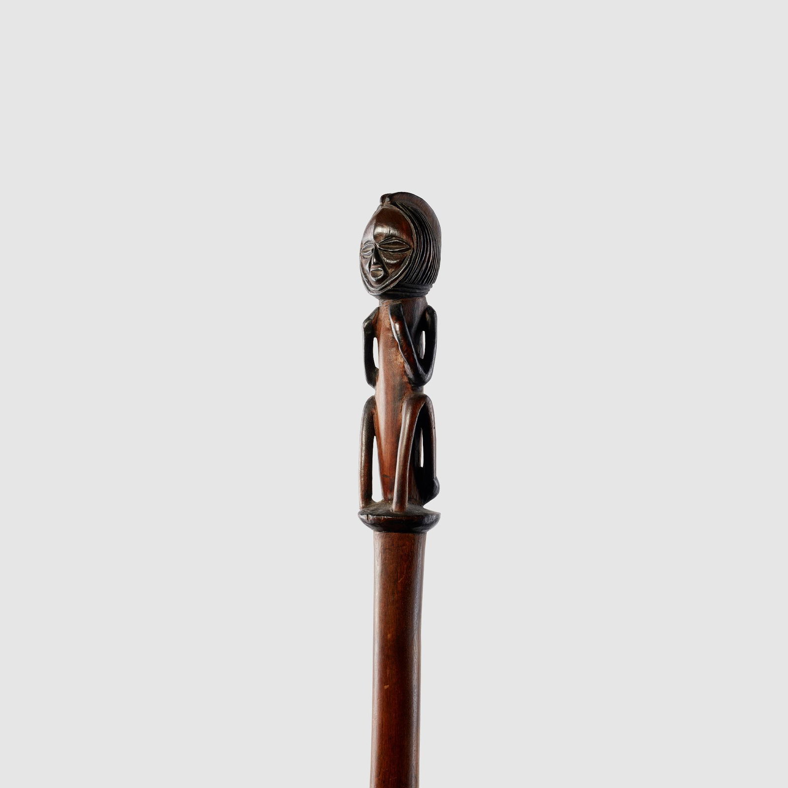 OVIMBINDU STAFF ANGOLA: carved wood, the long shaft terminating in a crouched figure finial (108cm tall) Bernice and Terence Pethica Collection, United Kingdom Peter Adler, London, United Kingdom Published: Klopper, Nettleto