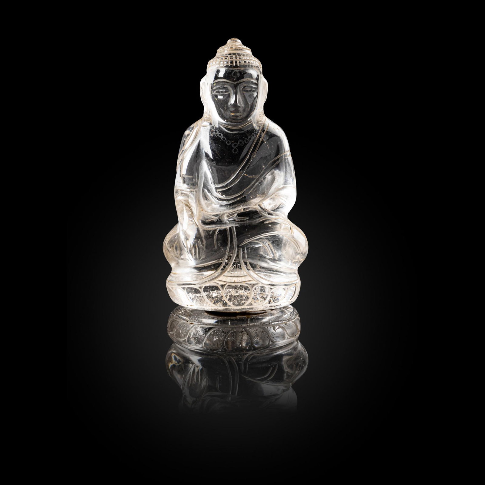 ROCK CRYSTAL CARVING OF A SEATED BUDDHA QING DYNASTY, 19TH CENTURY: ROCK CRYSTAL CARVING OF A SEATED BUDDHA QING DYNASTY, 19TH CENTURY 清 水晶雕釋迦摩尼佛座像 seated in dhyanasana with the right hand he