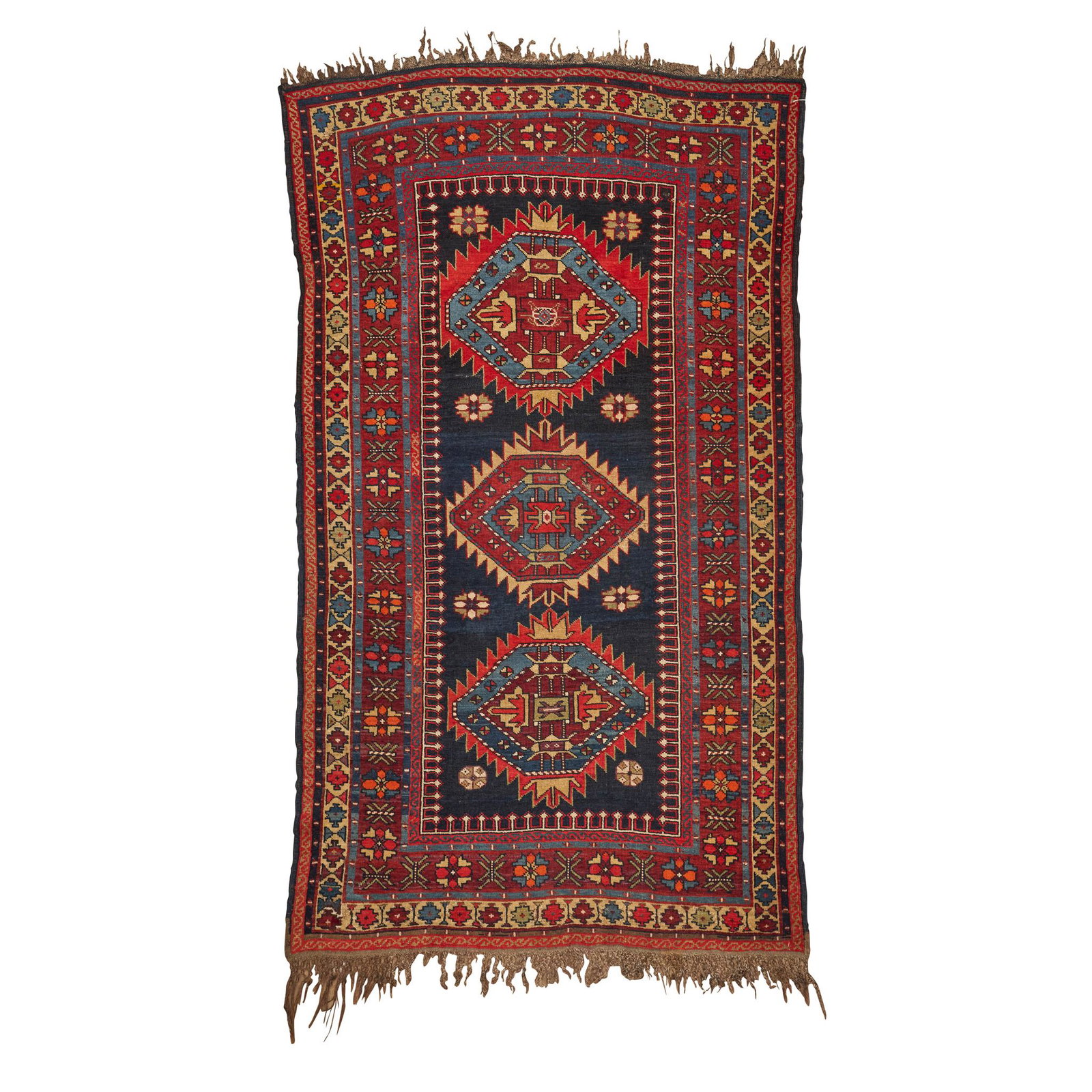 KUBA RUG EAST CAUCASUS, LATE 19TH/EARLY 20TH CENTURY: the indigo field with three serrated lozenge medallions, within brown border (172cm x 108cm)
