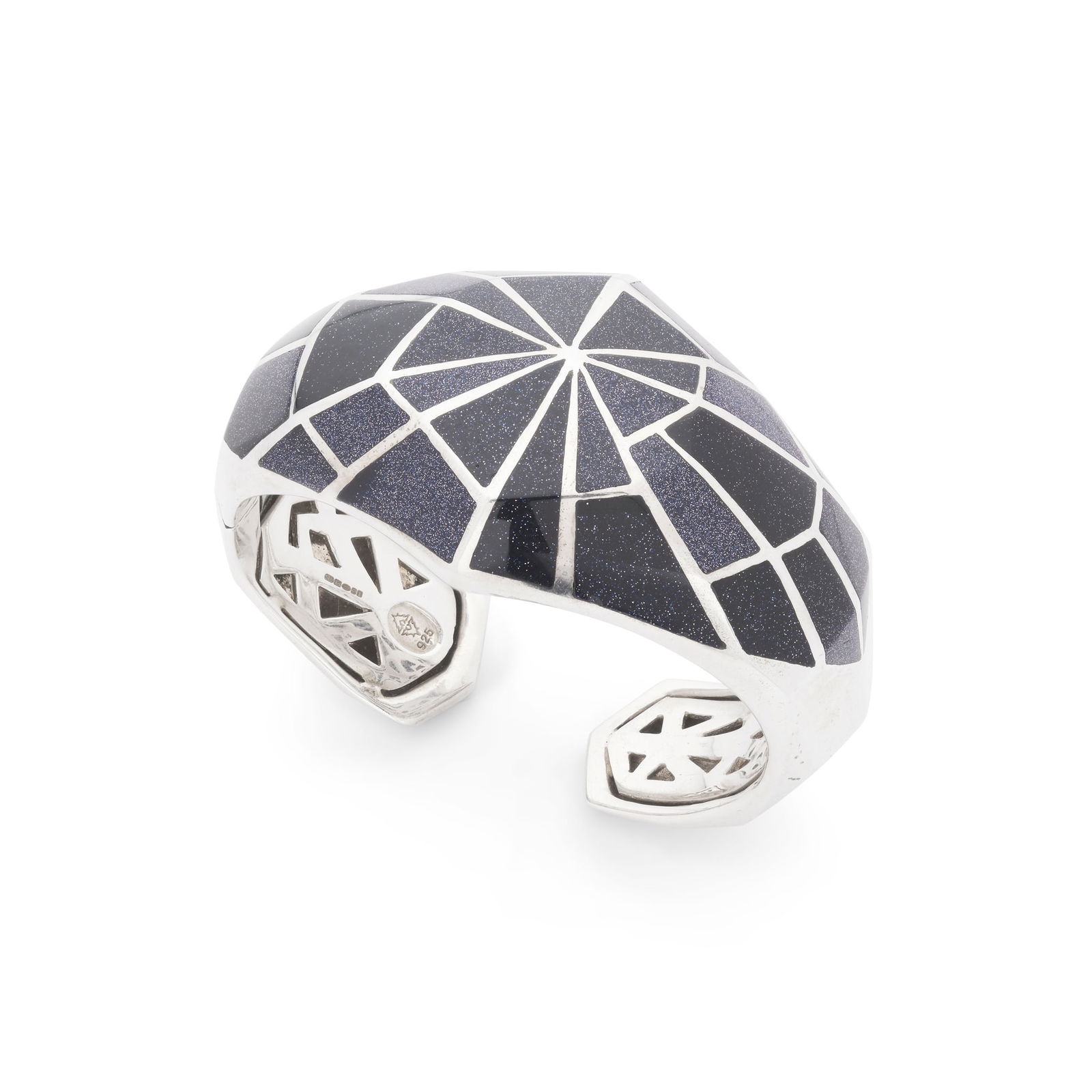 Stephen Webster: A 'Webbed Cuff' bangle: Stephen Webster: A 'Webbed Cuff' bangle Inlaid with blue goldstone in a webbed design, hinged, modelled in silver (Internal width: 6cm)