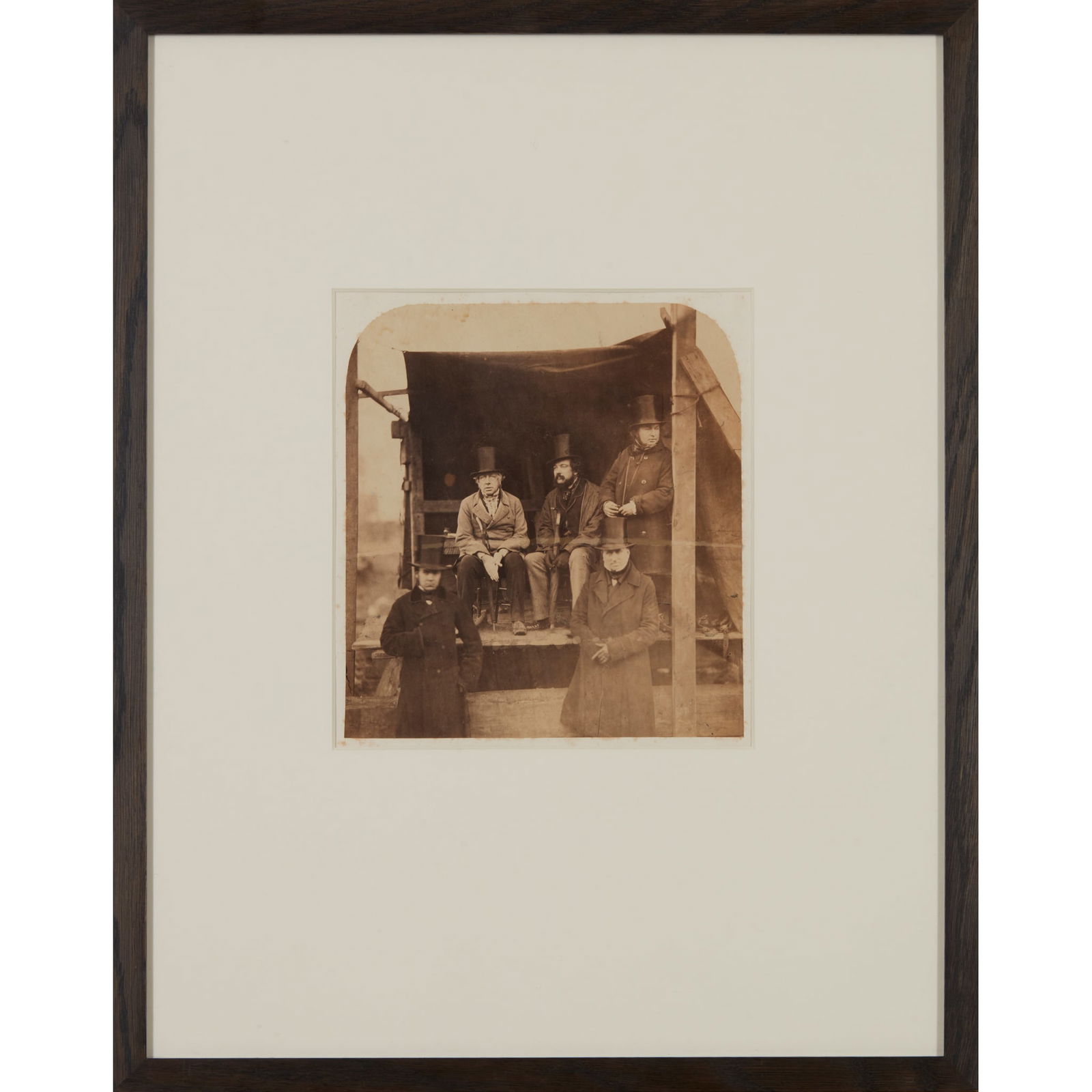 Robert Howlett (1831-1858) Group portrait of Isambard Kingdom Brunel and associates at the launching: Group portrait of Isambard Kingdom Brunel and associates at the launching of the Great Eastern, 1857 Arch-topped albumen print photograph (24 x 22cm), on old mount, framed and glazed, a few blemishes