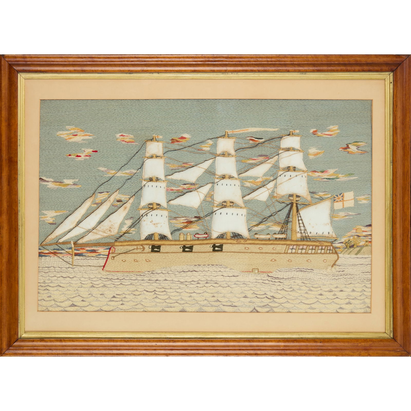 ENGLISH SAILOR'S 'WOOLIE' PICTURE: ENGLISH SAILOR'S 'WOOLIE' PICTURE 19TH CENTURY depicting a full-rigged ship with puffed woven sails and six guns, the sky with multicoloured clouds and setting sun on the right horizon line above a li