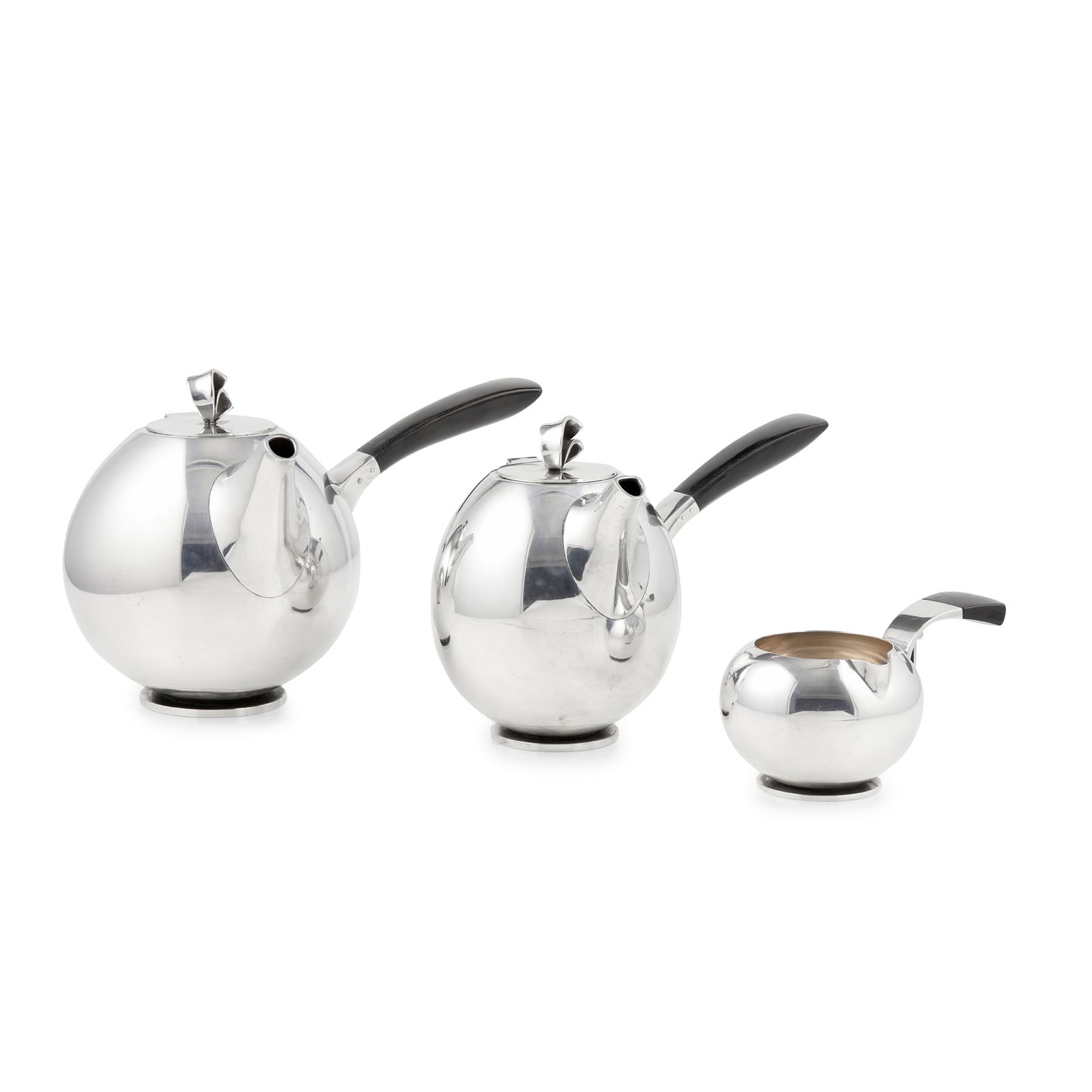 § AAGE WEIMAR (1902-1986): AAGE WEIMAR (1902-1986) THREE PIECE TEA SERVICE, 1930s Sterling silver, stained wood, comprising a TEAPOT, 16.3cm high; a HOT WATER JUG, 15cm high; and a CREAMER, 14cm wide, including handle, each wit