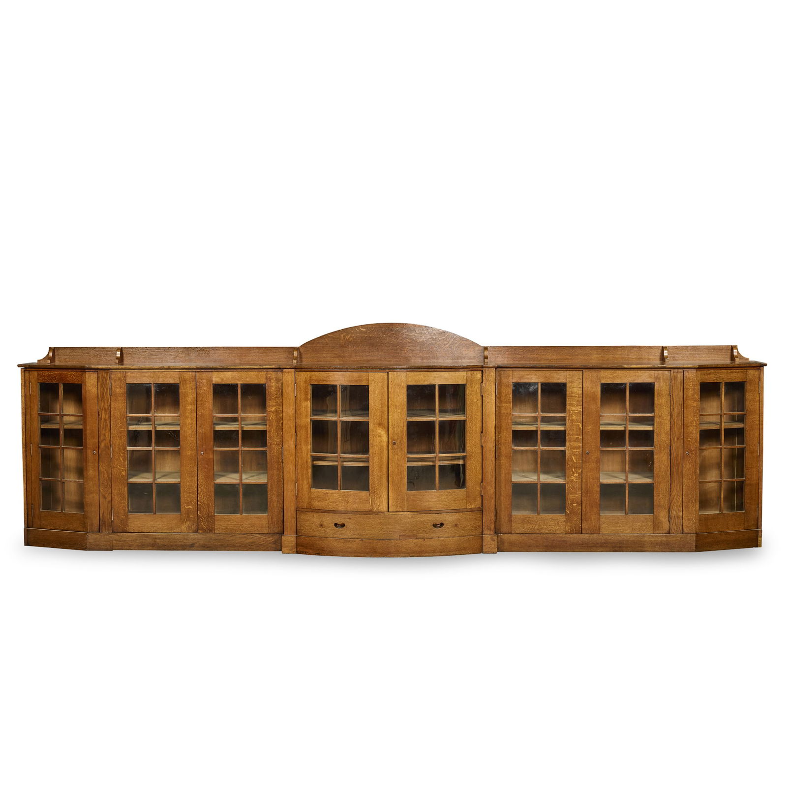 ATTRIBUTED TO GEORGE WALTON (1867-1933): ATTRIBUTED TO GEORGE WALTON (1867-1933) LOW BOOKCASE, CIRCA 1900 oak, with glazed doors and steel fittings 469cm wide, 141cm high, 61cm deep