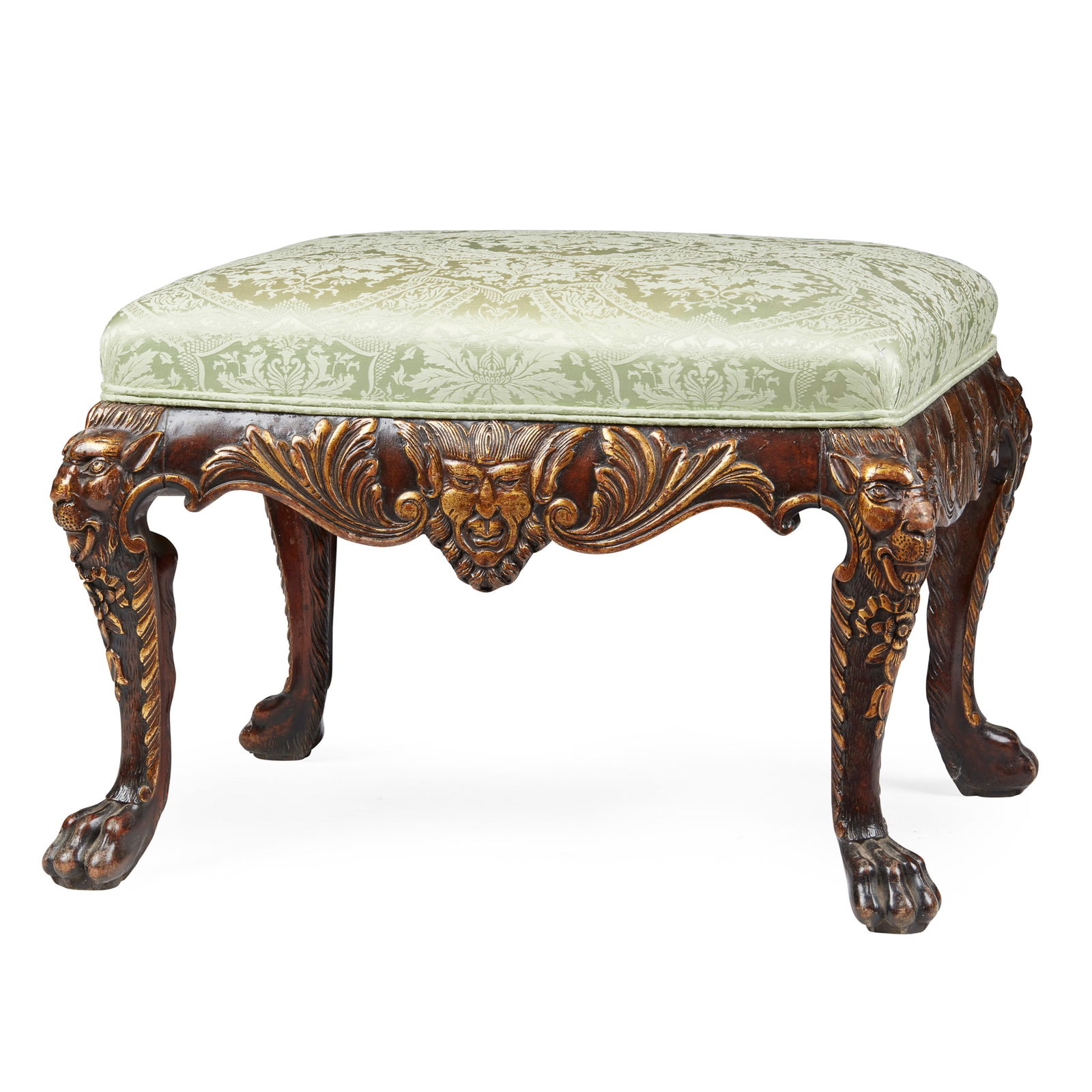 GEORGE II STYLE WALNUT AND PARCEL-GILT STOOL, IN THE MANNER OF WILLIAM KENT: GEORGE II STYLE WALNUT AND PARCEL-GILT STOOL, IN THE MANNER OF WILLIAM KENT 19TH CENTURY the drop-in padded seat over a shell and scroll carved seat rail, raised on lion mask carved cabriole legs with