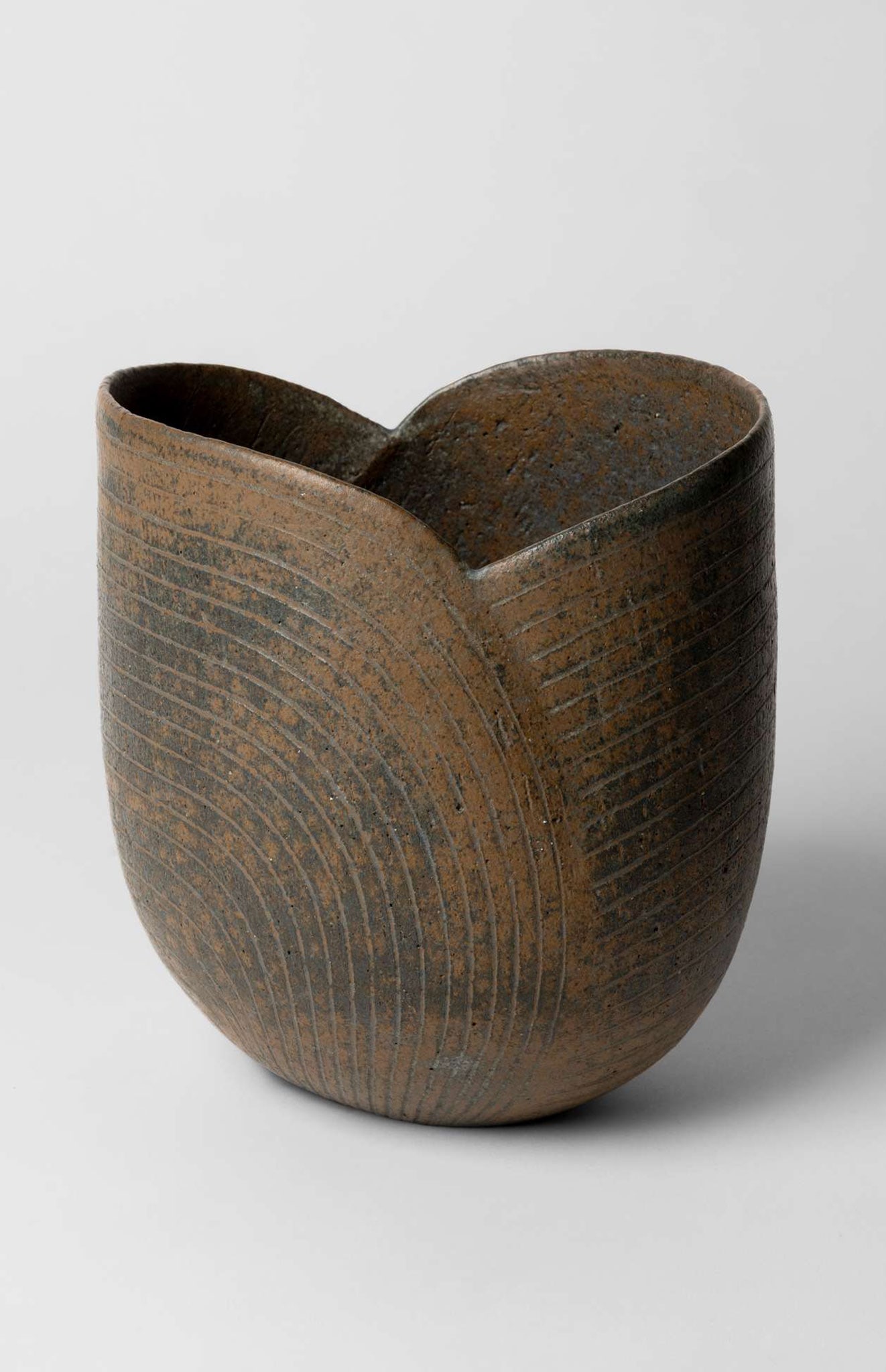 § JOHN WARD (BRITISH 1938-2023): JOHN WARD (BRITISH 1938-2023) VESSEL impressed maker's mark, stoneware, incised linear design 18cm high, 16.5cm wide (7in high, 6 ½in wide) Private Collection, U.K.
