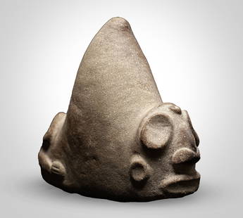 TAINO TRIGONOLITH
: TAINO TRIGONOLITH CARIBBEAN, 800 - 1500 A.D. carved stone, a tall conical central body rising from a flat base, a stylised zemi face is positioned at the front, featuring wide ovoid eyes, a prominent