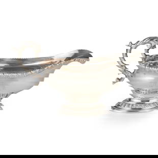 A GEORGE III SAUCEBOAT: A GEORGE III SAUCEBOAT PATRICK ROBERTSON, EDINBURGH 1786 of oval outline, the baluster body with gadrooned rim and spout and engraved crest and motto, raised on a short stem and oval gadrooned foot, w