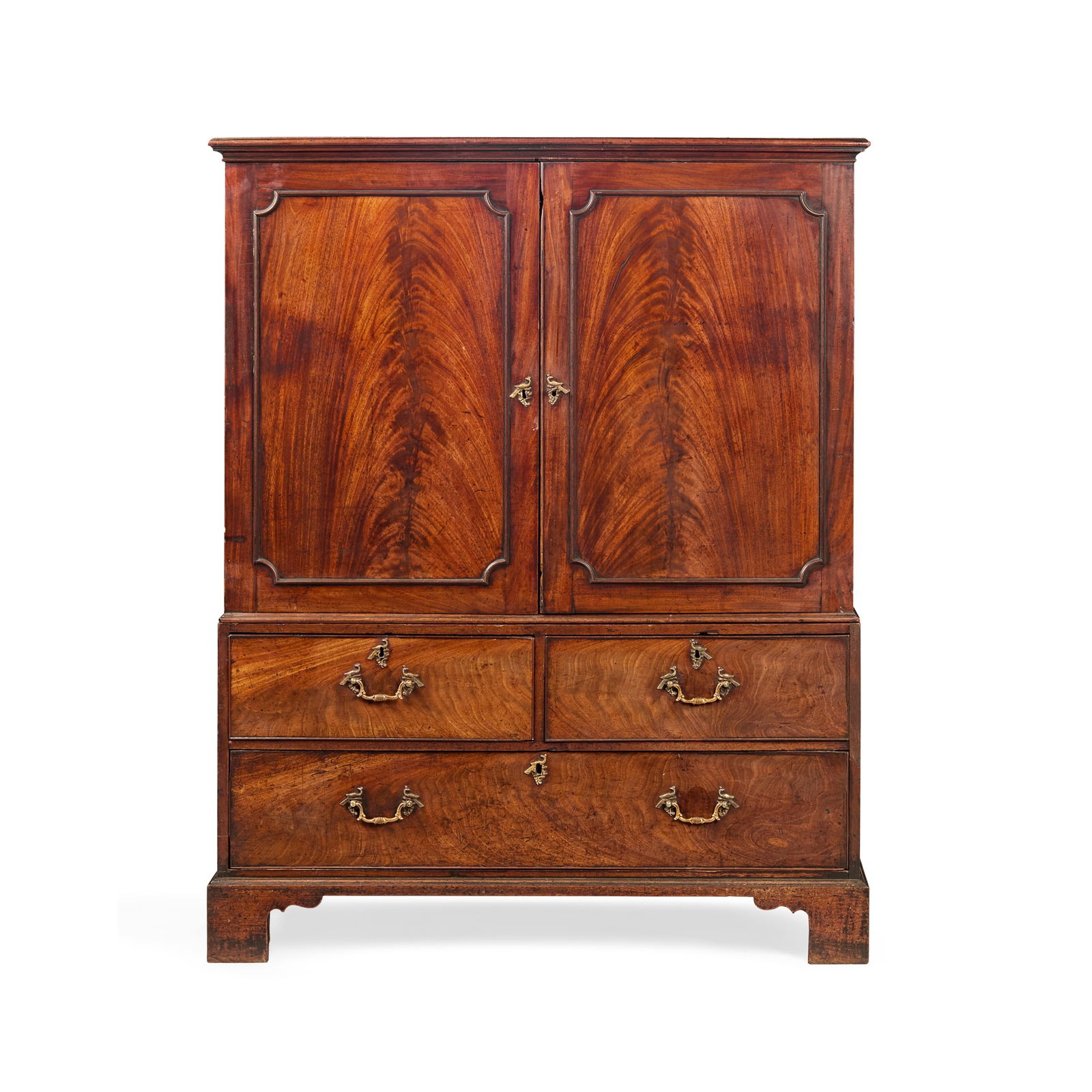GEORGE III MAHOGANY PRESS CUPBOARD, IN THE MANNER OF THOMAS CHIPPENDALE: GEORGE III MAHOGANY PRESS CUPBOARD, IN THE MANNER OF THOMAS CHIPPENDALE MID 18TH CENTURY the moulded cornice above a pair of moulded panel doors enclosing sliding trays; the base with two short drawer