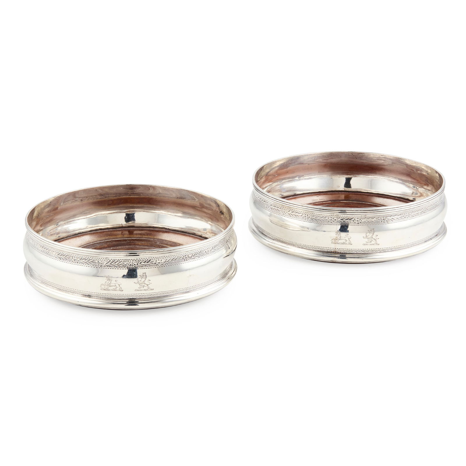A PAIR OF GEORGE III COASTERS: A PAIR OF GEORGE III COASTERS DUBLIN 1806 Each of circular outline, Bright-cut engraved foliate border, double crest engraved to body, wooden lined bases 14cm diameter 