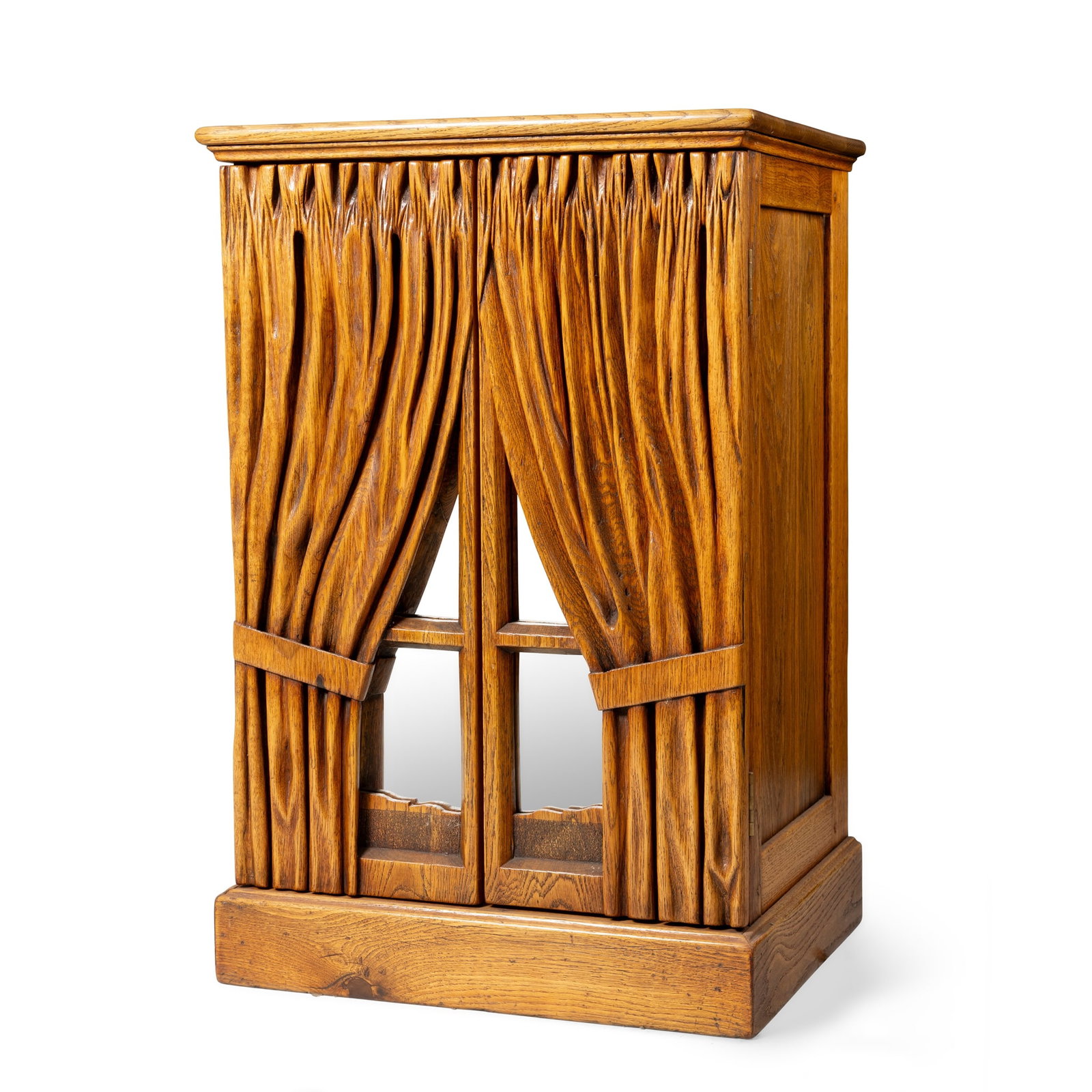 A PAIR OF OAK SIDE CABINETS: A PAIR OF OAK SIDE CABINETS 20TH CENTURY the rectangular tops over a pair of doors modelled as a pair of curtain across a window (2) 61cm wide x 92cm high x 49cm deep