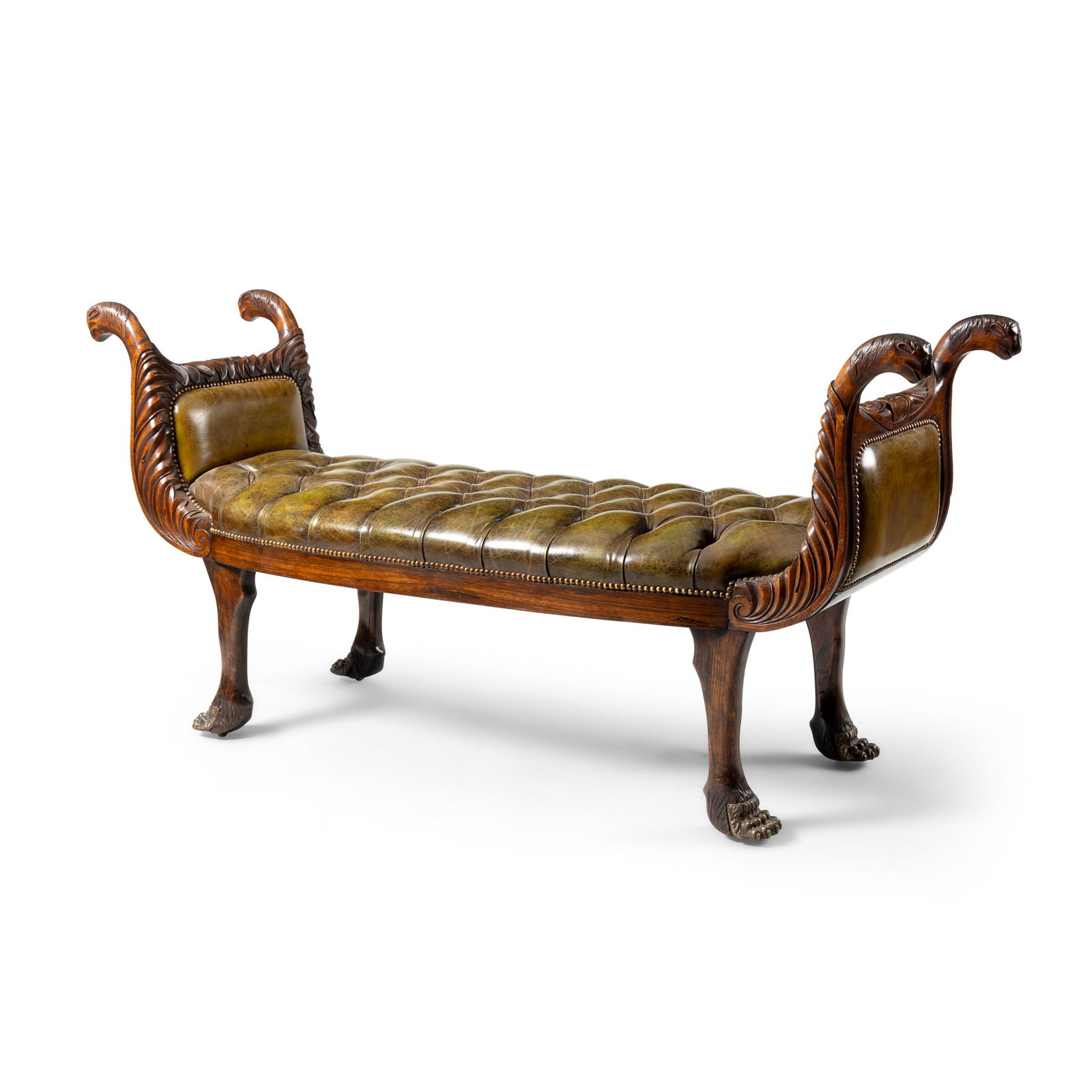 A WALNUT AND GREEN LEATHER WINDOW SEAT: A WALNUT AND GREEN LEATHER WINDOW SEAT 19TH CENTURY the bowed front rail flanked by foliate carved upswept arms terminating in lion head finials, the seat button upholstered, raised on lion paw suppor