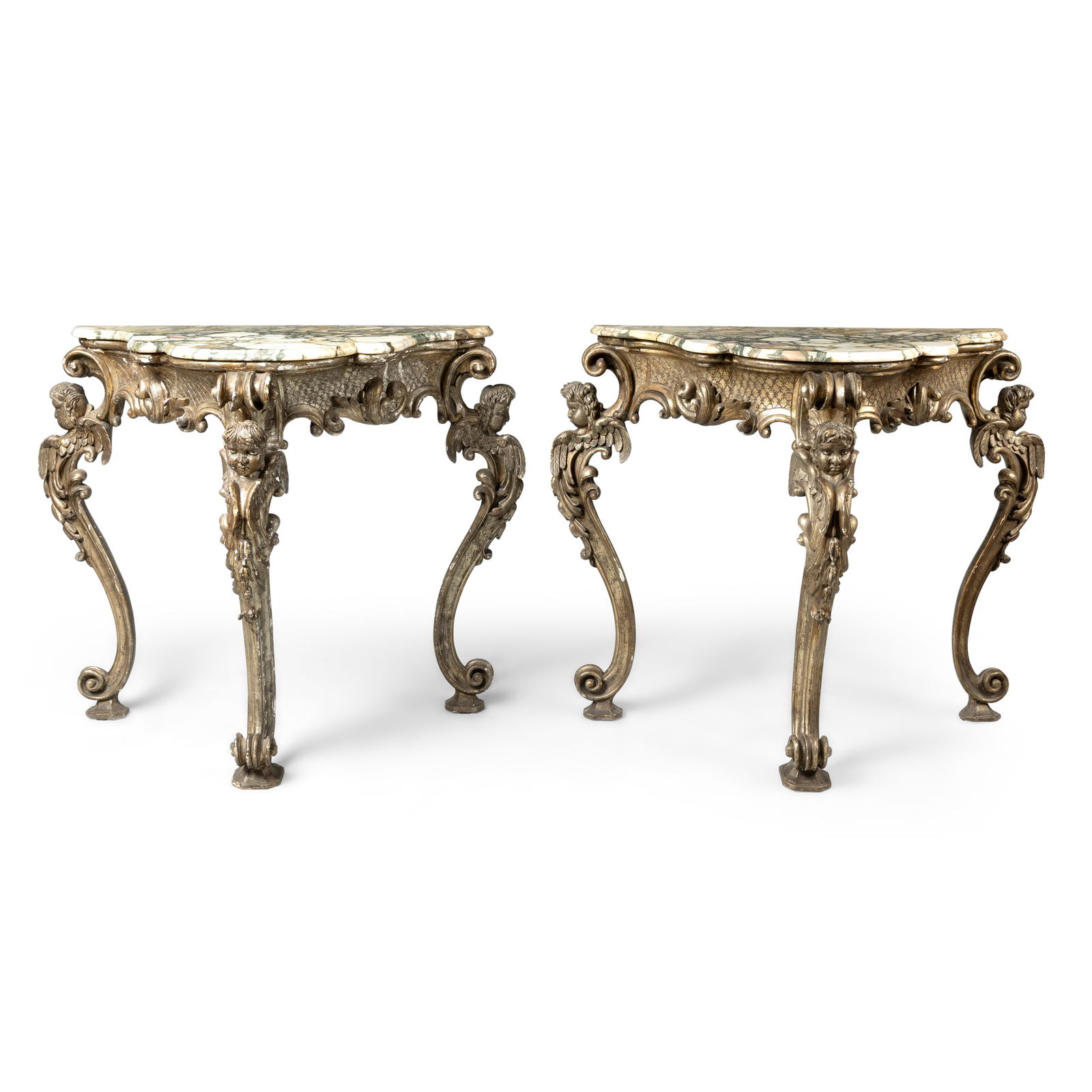 A PAIR OF ITALIAN SILVERED WOOD AND GESSO CONSOLE TABLES: A PAIR OF ITALIAN SILVERED WOOD AND GESSO CONSOLE TABLES 18TH CENTURY of exaggerated proportions, the serpentine breche violette marble tops above a scroll-carved diaper-work apron, on four scroll and
