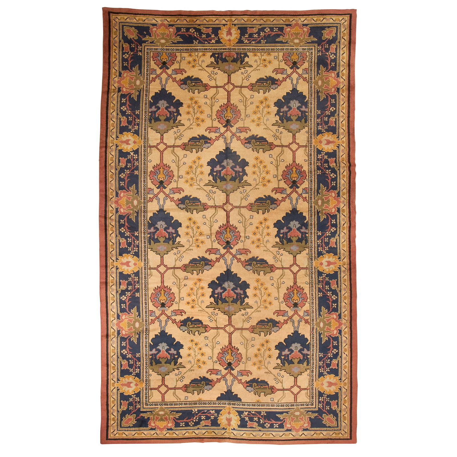 AFTER GAVIN MORTON AND G.K. ROBERTSON: AFTER GAVIN MORTON AND G.K. ROBERTSON LARGE ARTS & CRAFTS HAND-KNOTTED CARPET wool, the ivory field having all-over decoration of bold palmettes and stiff leaves in blue, green and pastel enclosed by
