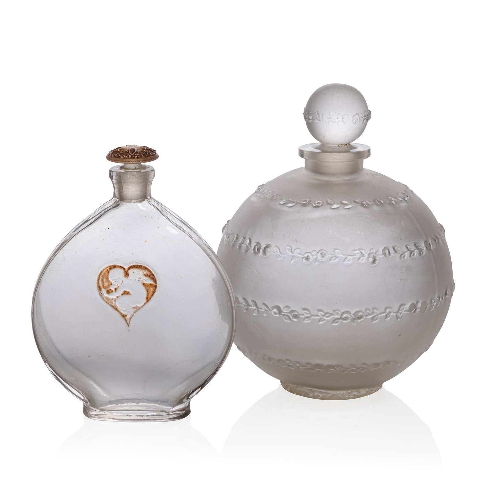 RENÉ LALIQUE (1860-1945): RENÉ LALIQUE (1860-1945) ROSE SANS FIN SCENT BOTTLE, ARYS - 3 designed 1916clear and frostedmoulded ARYStogether with L'AMOUR DANS LE COEUR SCENT BOTTLE, ARYS - 5designed 1920clear, frosted 
