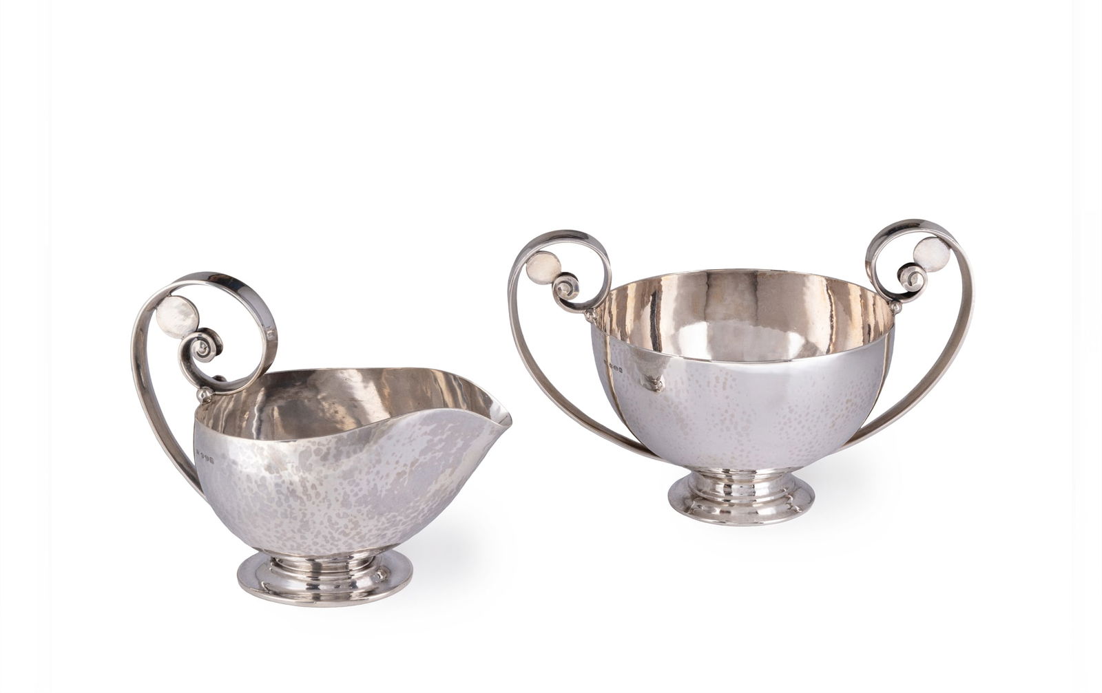 JOHAN ROHDE (DANISH 1856-1935) FOR GEORG JENSEN: JOHAN ROHDE (DANISH 1856-1935) FOR GEORG JENSEN SUGAR BOWL AND CREAM JUG model numbers 321A and 321B, each stamped manufacturer's mark and model number and the sugar bowl stamped DENMARK / STERLING, t