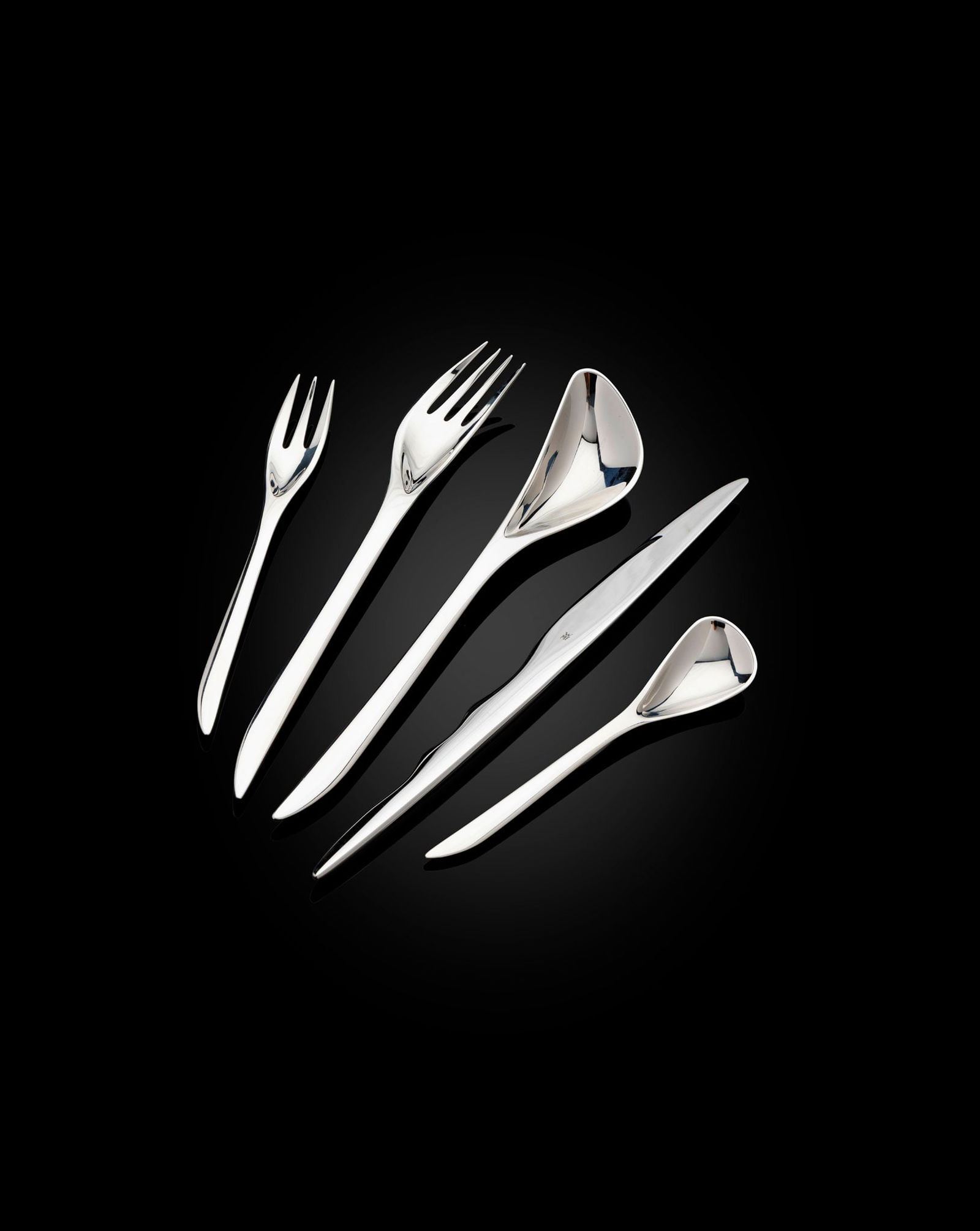 § ZAHA HADID D.B.E., R.A. (BRITISH 1950-2016) FOR WMF: ZAHA HADID D.B.E., R.A. (BRITISH 1950-2016) FOR WMF EIGHT FIVE-PIECE 'ZAHA' CUTLERY SETS, DESIGNED 2007 with manufacturer's marks, stainless steel, comprising 8 knives, 8 forks, 8 small forks, 8 spoon