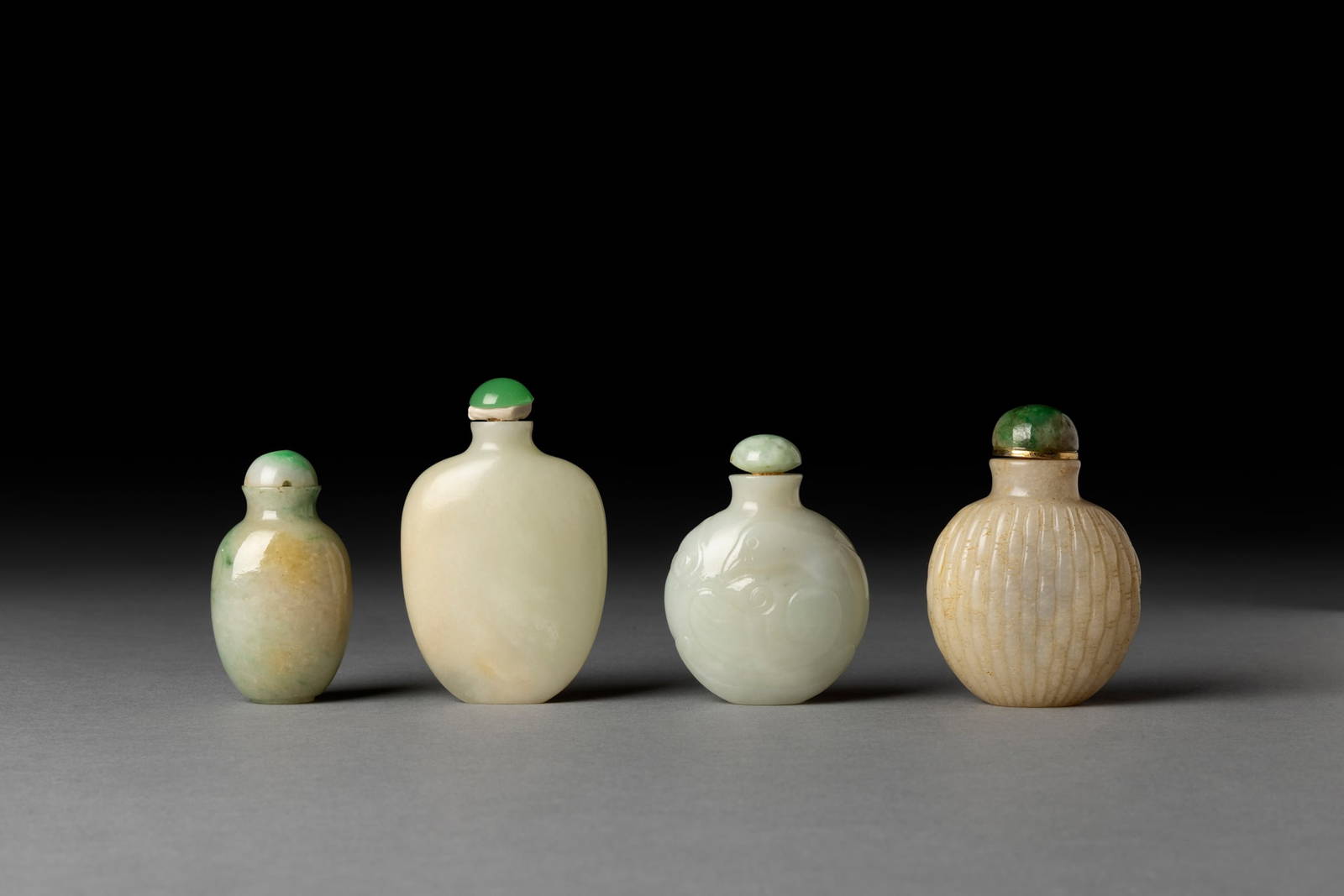 [COLLECTION OF PROF. J. GILBERT & CORA MCALLISTER] GROUP OF FOUR CHINESE JADE AND JADEITE SNUFF