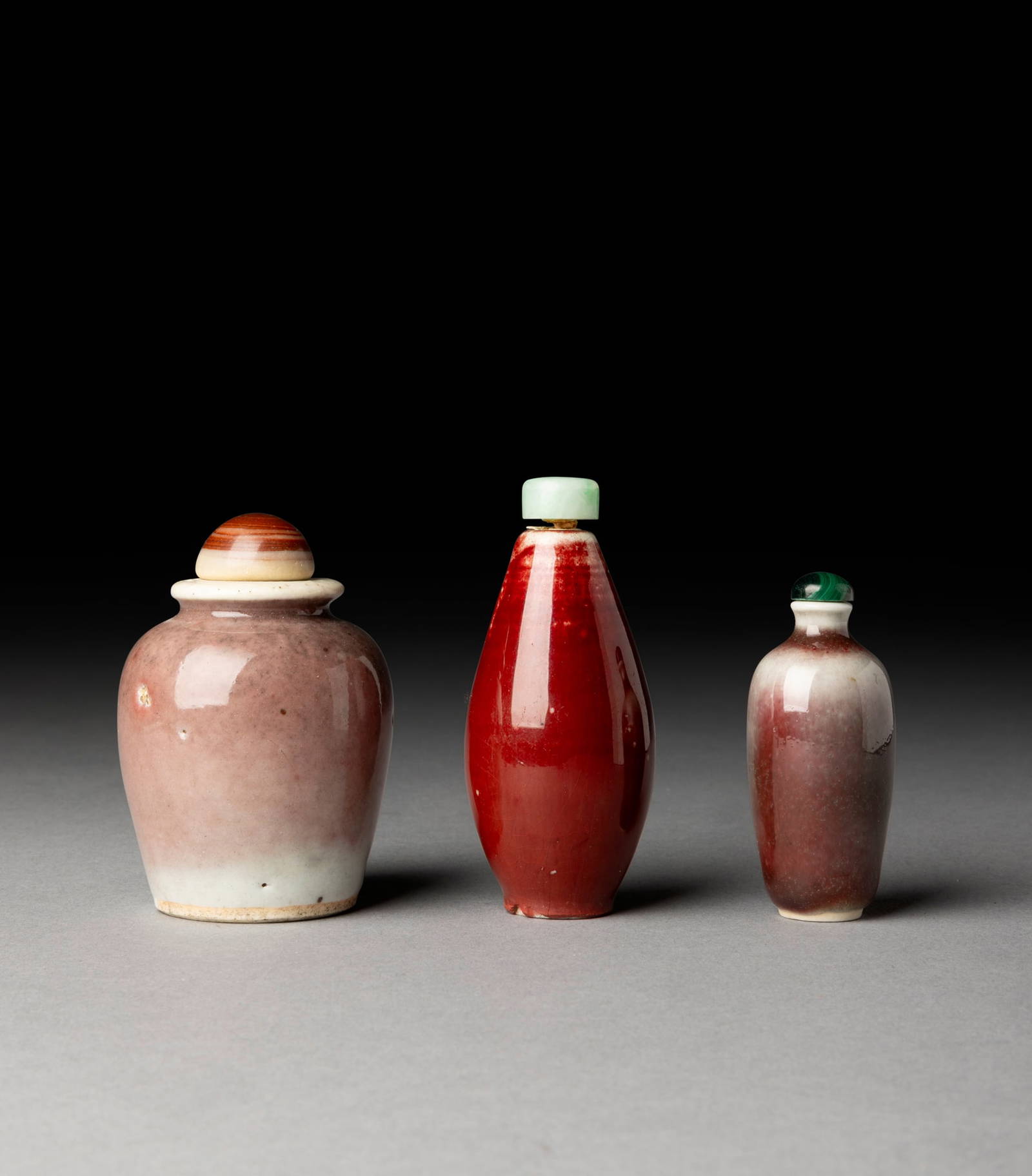 [COLLECTION OF PROF. J. GILBERT & CORA MCALLISTER] GROUP OF THREE CHINESE RED-GLAZED SNUFF BOTTLES