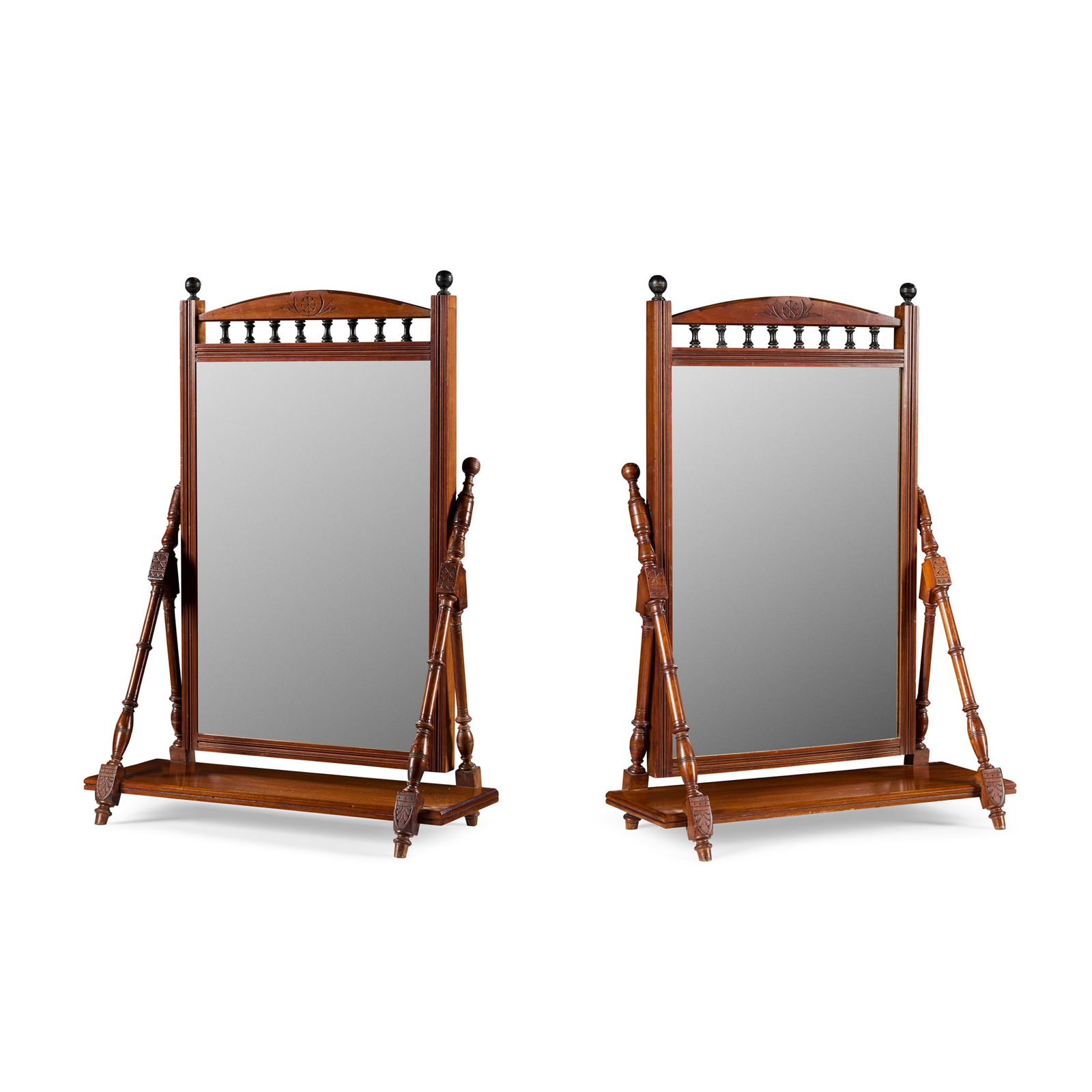 PAIR OF AESTHETIC MOVEMENT MAHOGANY AND EBONISED DRESSING TABLE MIRRORS: PAIR OF AESTHETIC MOVEMENT MAHOGANY AND EBONISED DRESSING TABLE MIRRORS LATE 19TH CENTURY the rectangular mirror plates surmounted by a spindle gallery and laurel wreath carved pediment, and enclosed