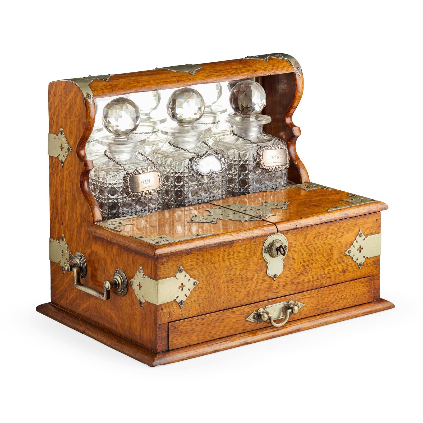 EDWARDIAN OAK TANTALUS/ GAMES COMPENDIUM: EDWARDIAN OAK TANTALUS/ GAMES COMPENDIUM EARLY 20TH CENTURY with pierced silver plated mounts throughout, the top applied with a shield shaped cartouche inscribed with the monogram ‘SG’, c