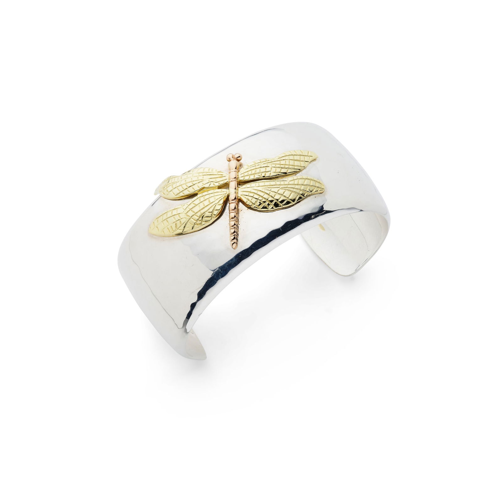 Tiffany & Co.: A 'Dragonfly' cuff: Tiffany & Co.: A 'Dragonfly' cuff The cuff with light hammered finish and applied gilt dragonfly motif, stamped 2001, signed, 925 750; with pochette and outer cardboard box Internal width: 5.8cm