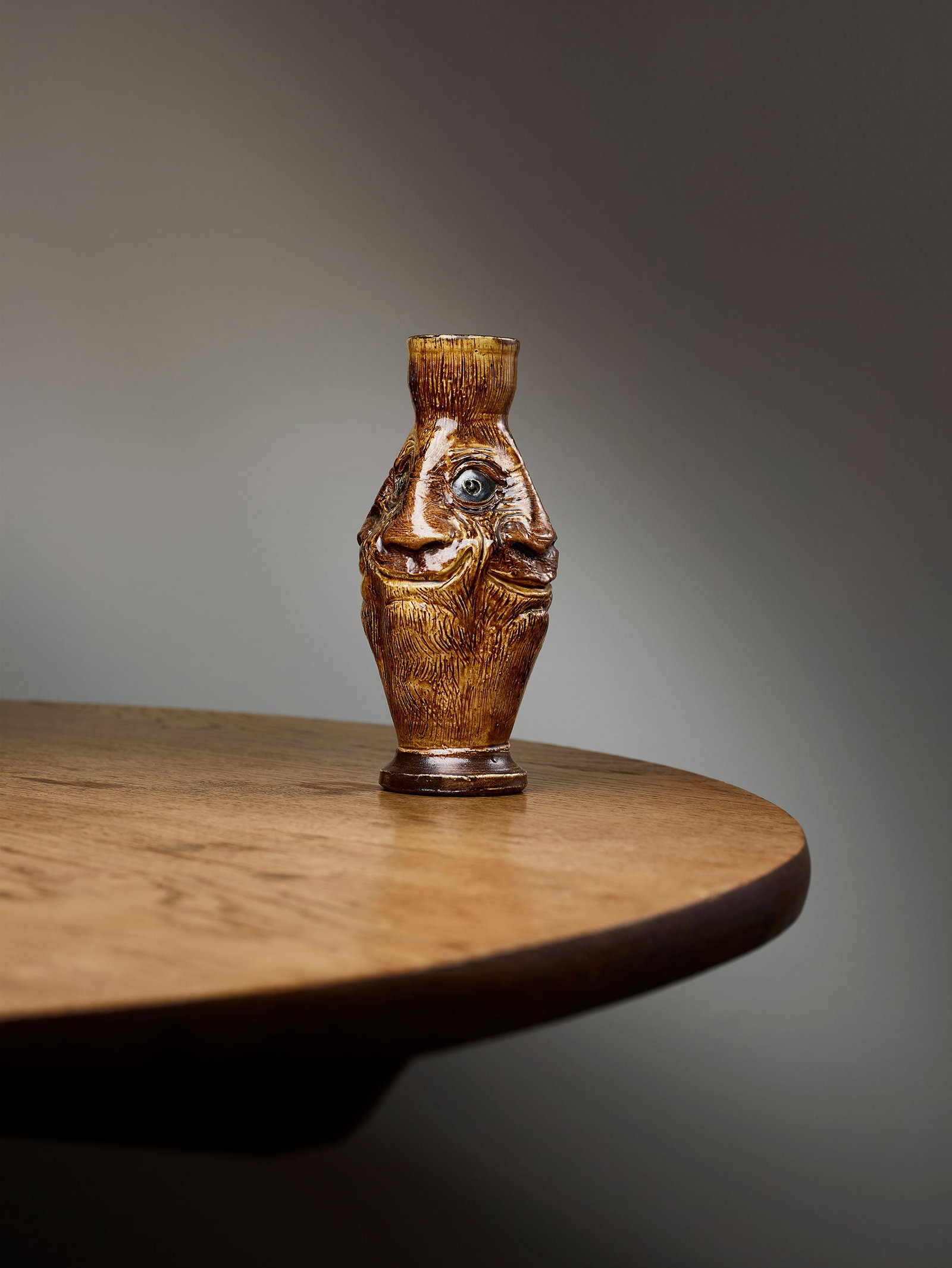 MARTIN BROTHERS: MARTIN BROTHERS FACES VASE, 1884 incised MARTIN BRO LONDON & SOUTHALL / 6-84, glazed stoneware 23.7cm high Cheffins, 26 May 2022, lot 50.Hugo Burge Collection The Martin Brothers, Robert W