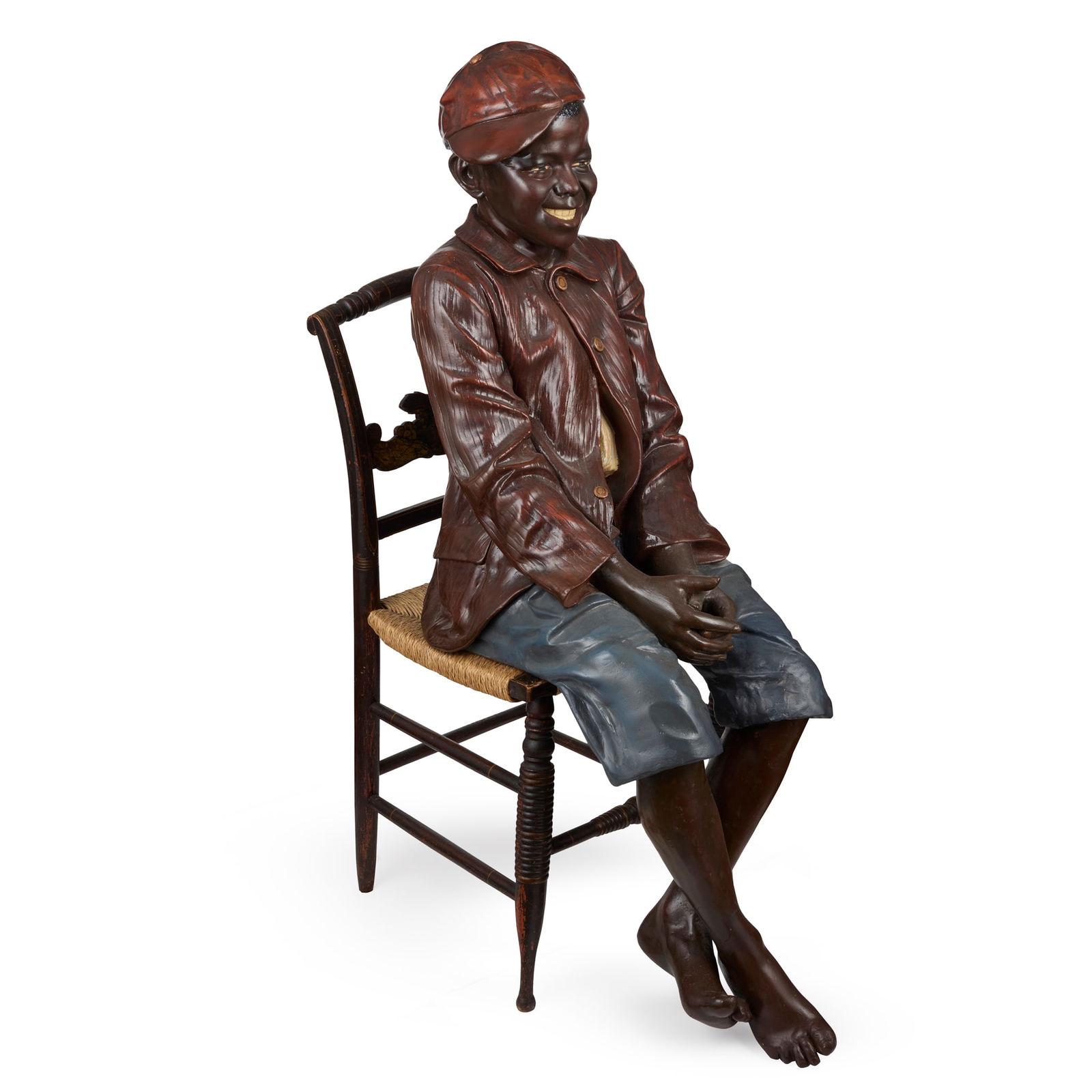FRIEDRICH GOLDSCHEIDER (1845–1897): FRIEDRICH GOLDSCHEIDER (1845–1897) FIGURE OF A SEATED BOY, CIRCA 1900 polychrome-decorated terracotta, on a painted ebonised and giltwood chair with rush seat 122cm high, 39cm wide, 58cm deep