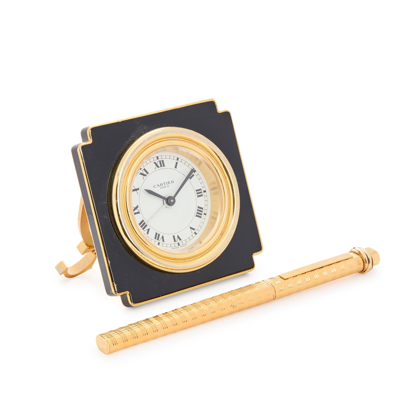 Must de Cartier. A gilt metal mechanical 8 day desk alarm clock and ballpoint pen (1 of 3)