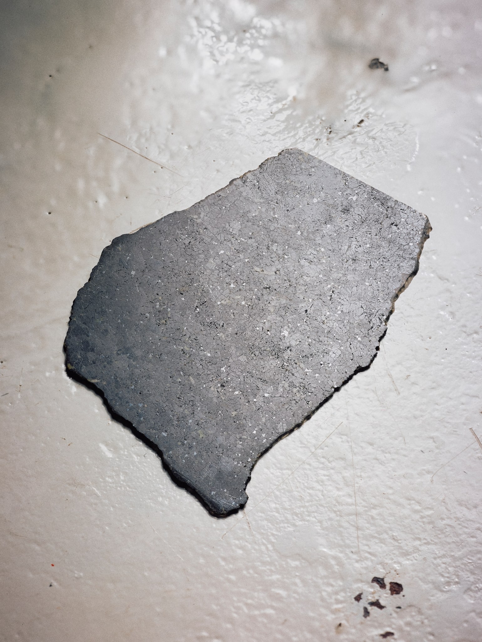 A SLICE OF THE PLANET MARS: A SLICE OF THE PLANET MARS NWA 2737, CHASSIGNITE one of the rarest objects on Earth, a specimen of rock from the planet Mars, coarse-grained olivine, set within a dark grey crystalline matrix, with fi
