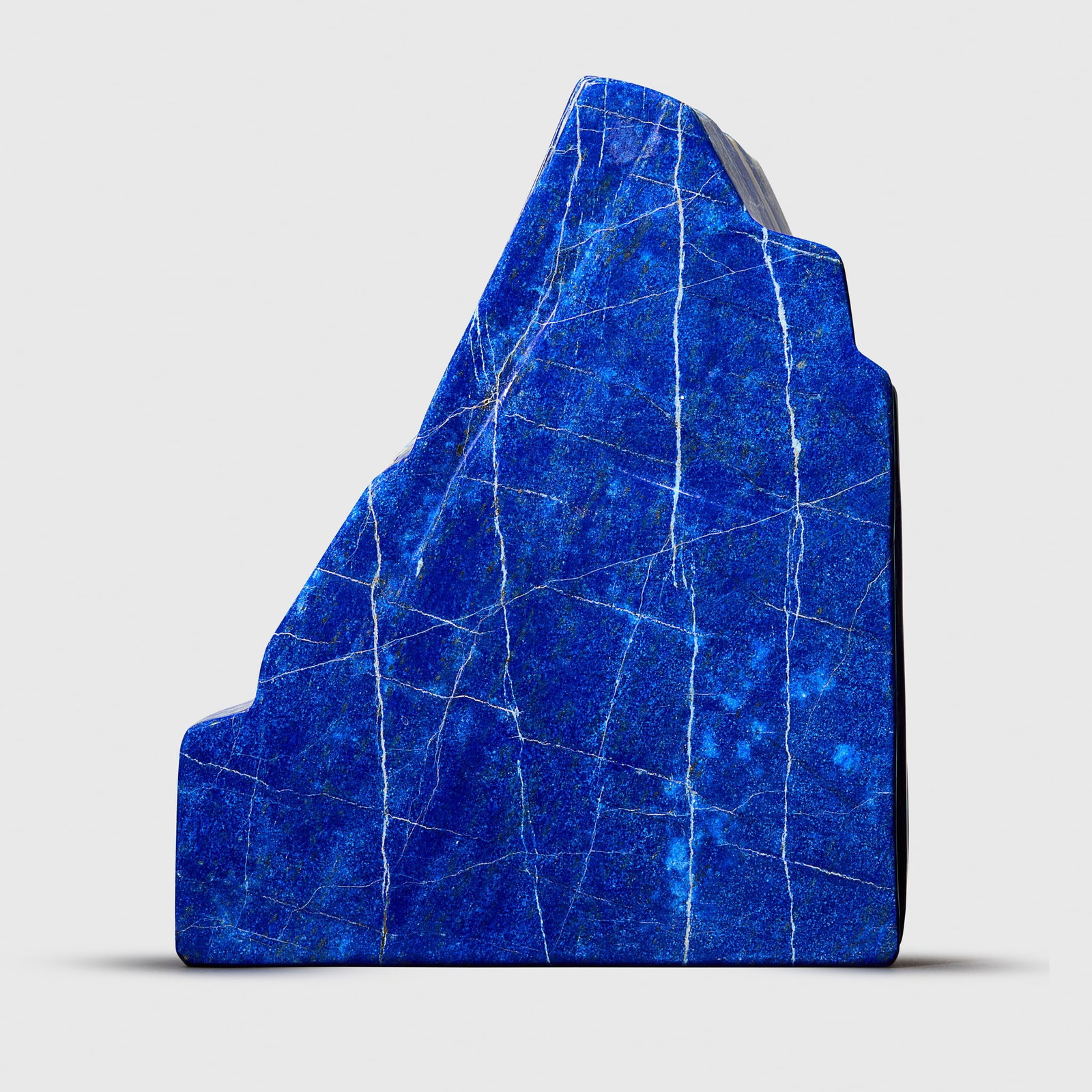 LARGE SPECIMEN OF LAPIS LAZULI: LARGE SPECIMEN OF LAPIS LAZULI SAR-I-SANG, AFGHANISTAN deep blue, cut and polished, with thin veining and pyrite deposits Weight: 8758g Height: 28.8cm A large and impressive specimen of lap