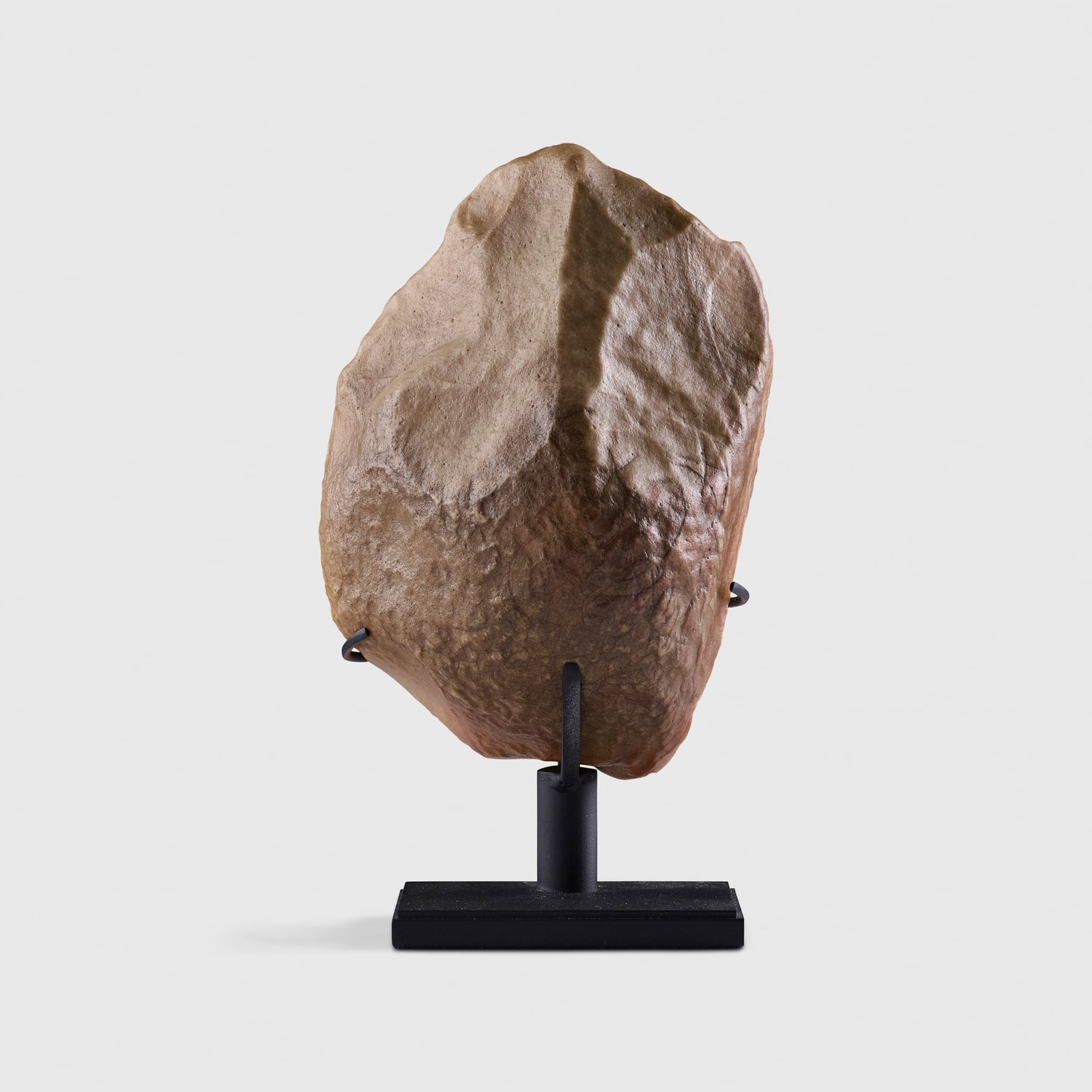 ACHEULEAN STONE CHOPPER: ACHEULEAN STONE CHOPPER MOROCCO, LOWER PALEOLITHIC, C. 1,000,000 YEARS BEFORE PRESENT knapped grey stone, of protobiface form, raised on a bespoke mount 14.9cm tall Private collection, Belgium, by des