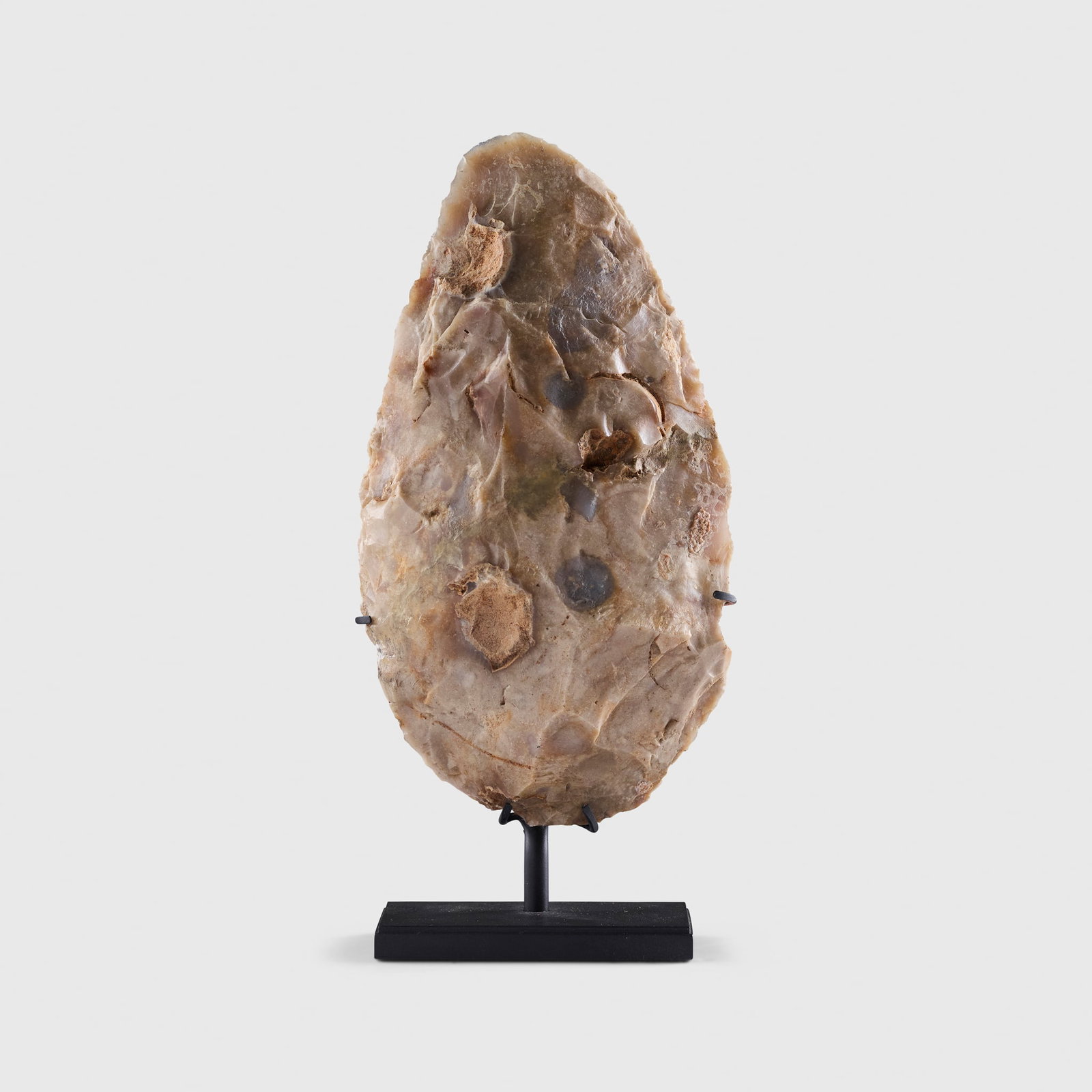 FLINT HANDAXE: FLINT HANDAXE OISE, NORTHERN FRANCE, PALEOLITHIC PERIOD, C. 300,000 ? 100,000 B.C. knapped flint, a large and impressive silver and grey flint handaxe, uncovered in Oise, northern France, raised on a 