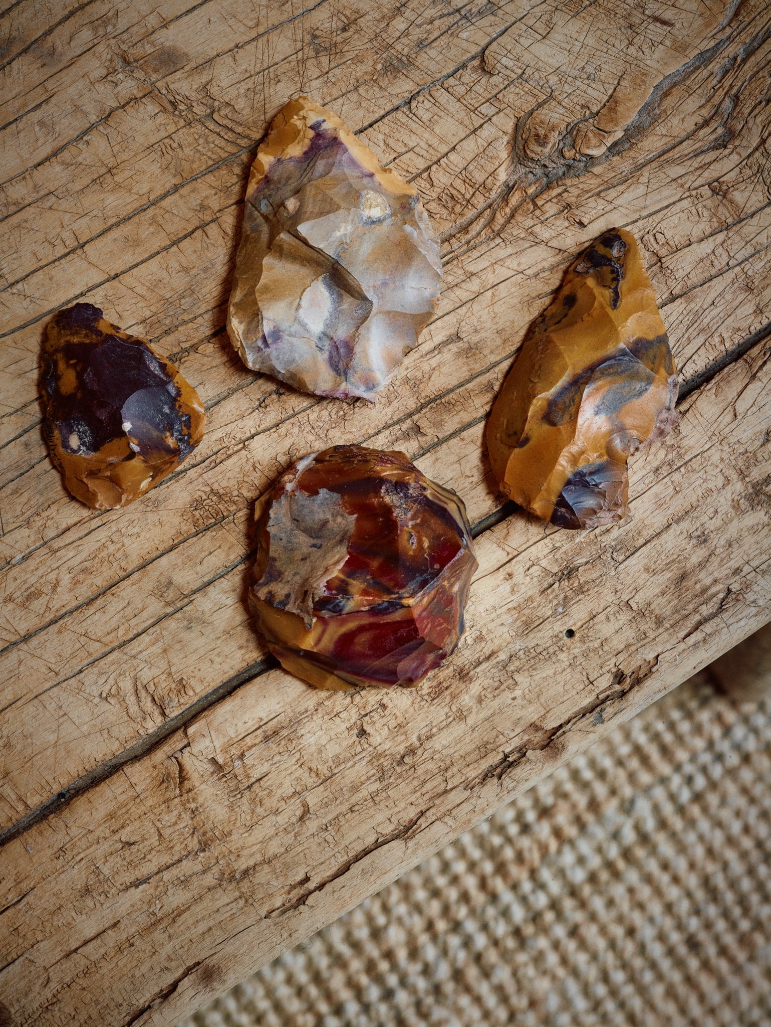 NEANDERTHAL JASPER TOOLS: NEANDERTHAL JASPER TOOLS MIDDLE PALEOLITHIC, FONTMORE, CENTRAL FRANCE, C. 300,000 - 40,000 B.P. knapped jasper, a collection of four bifaces, ranging from 5.3 to 10.2 cm long, each displaying a vibran