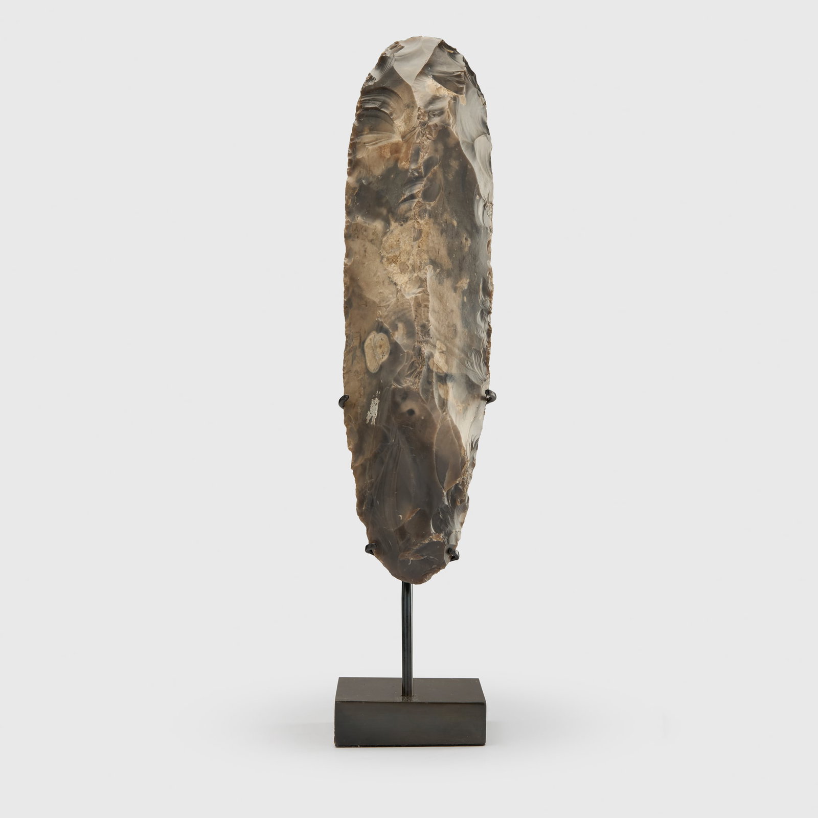 LARGE BRITISH NEOLITHIC FLINT AXEHEAD: LARGE BRITISH NEOLITHIC FLINT AXEHEAD UNITED KINGDOM, NEOLTHIC PERIOD, C. 3500 B.C. knapped flint, of elongated oval form, bifacially-flaked, sightly tapering butt and rounded cutting edge,