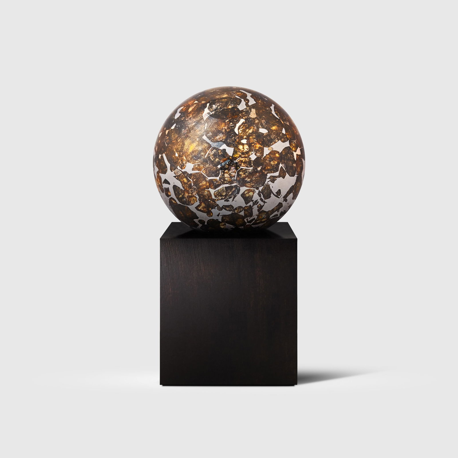 PALLASITE METEORITE SPHERE: PALLASITE METEORITE SPHERE SEYMCHAN, MAGADAN DISTRICT, RUSSIA (62?54? N, 152?26? E), FORMED 4.56 BILLION YEARS B.P. the sphere with abundant olivine crystals suspended within the iron-nickel matrix, r