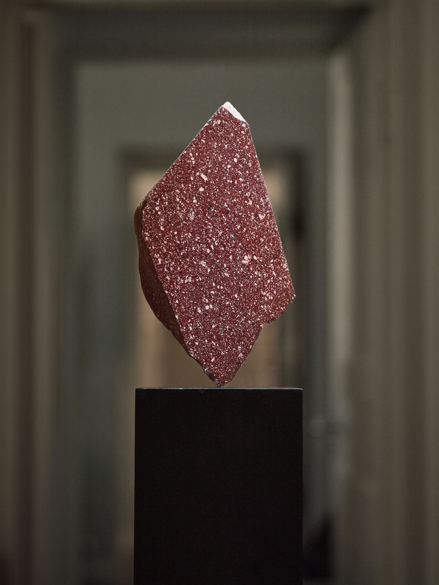 LARGE FRAGMENT OF ROMAN IMPERIAL PORPHYRY: LARGE FRAGMENT OF ROMAN IMPERIAL PORPHYRY GEBEL DOKHAN, EGYPT, C. 1ST ? 5TH CENTURY A.D. cut porphyry, front likely re-polished in the 18th century, exhibiting a deep reddish-purple ground with scatte