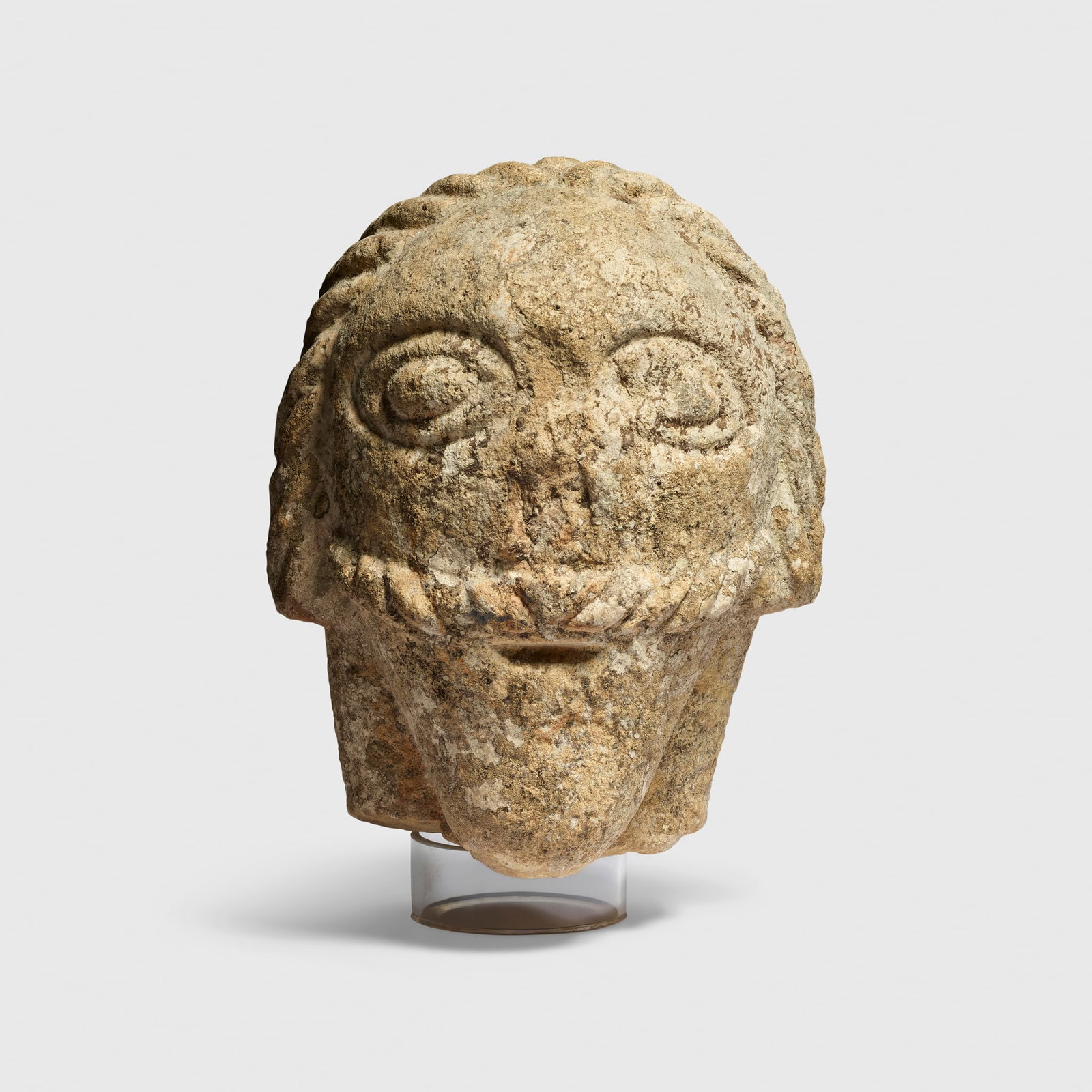 CELTIC STONE HEAD: CELTIC STONE HEAD SOUTHWEST ENGLAND, C. LATE FIRST MILLENNIUM B.C. - EARLY FIRST MILLENNIUM A.D. carved granite, the head compact and rounded, with a broad, flattened nose and almond-shaped eyes benea