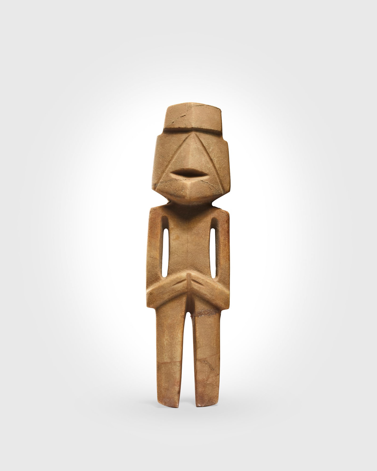 MEZCALA FIGURE: MEZCALA FIGURE GUERRERO, MEXICO, LATE PRECLASSIC, C. 300 ? 100 B.C. carved calcite, the abstracted figure with broad torso, arms folded into the waist, the head with recessed horizontals planes indica