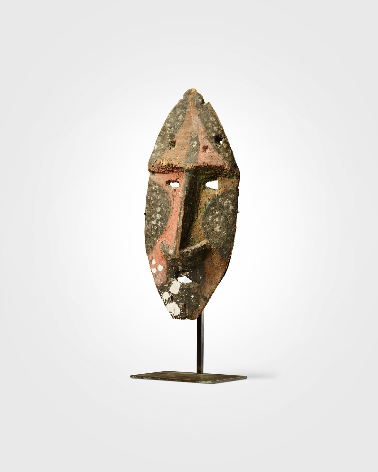 MALEKULA GRADE MASK: MALEKULA GRADE MASK MALEKULA ISLAND, VANUATU carved wood and pigment, tapering form with a pointed chin, a pronounced central ridge forms a long, narrow nose, flanked by shallow, recessed eye aperture
