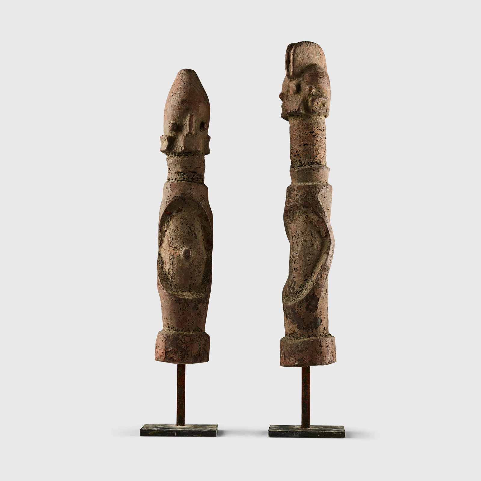 PAIR OF WURKUN KUNDUL FIGURES: PAIR OF WURKUN KUNDUL FIGURES NIGERIA carved wood, fibre binding and iron, each of strongly stylised form, with a cylindrical body and surmounted by a large head on an elongated neck with fibre bindin
