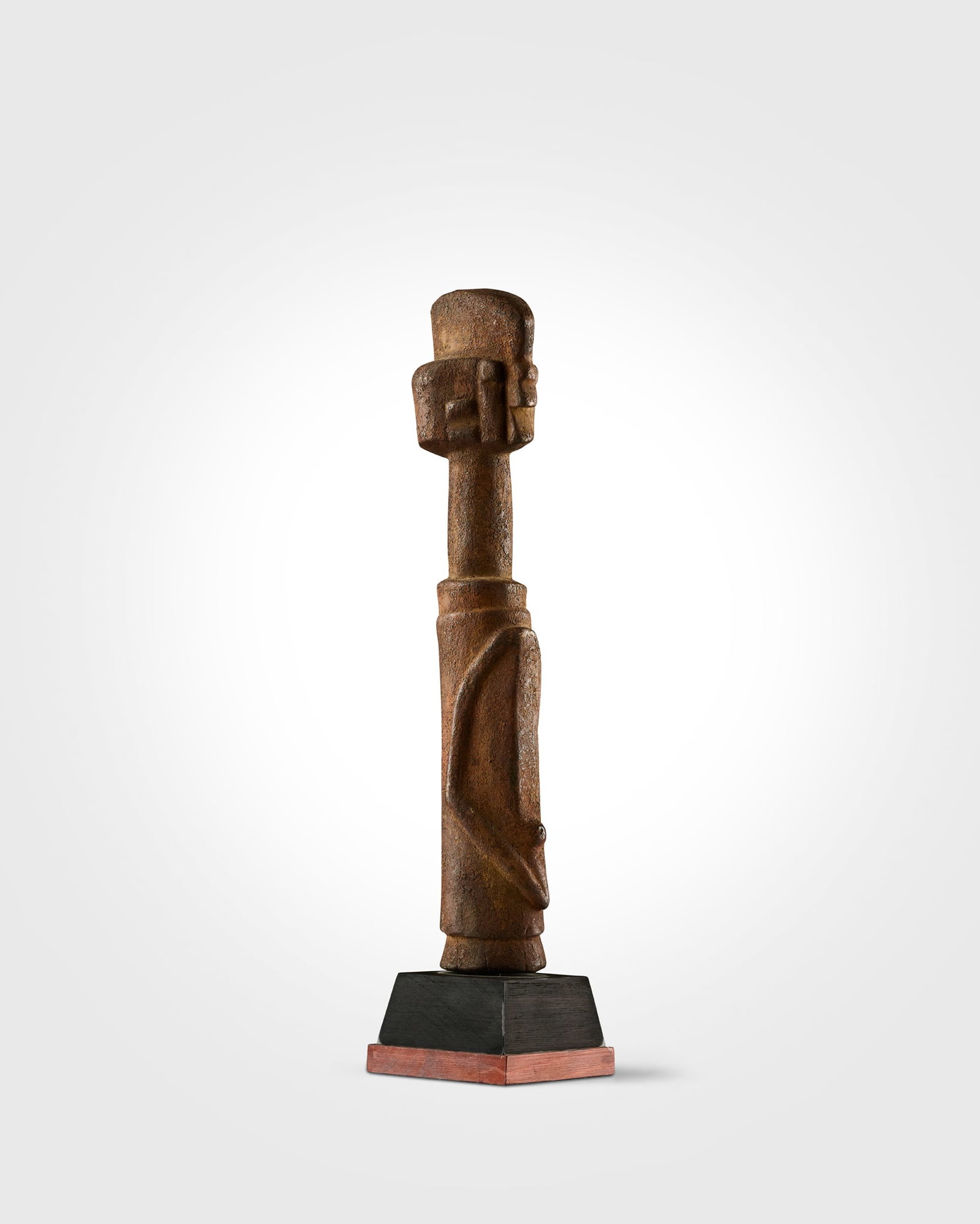 WURKUN KUNDUL FIGURE: WURKUN KUNDUL FIGURE NIGERIA carved wood, of strongly stylised form, with a cylindrical body and surmounted by a large head on an elongated neck, the facial features are rendered in a restrained manne