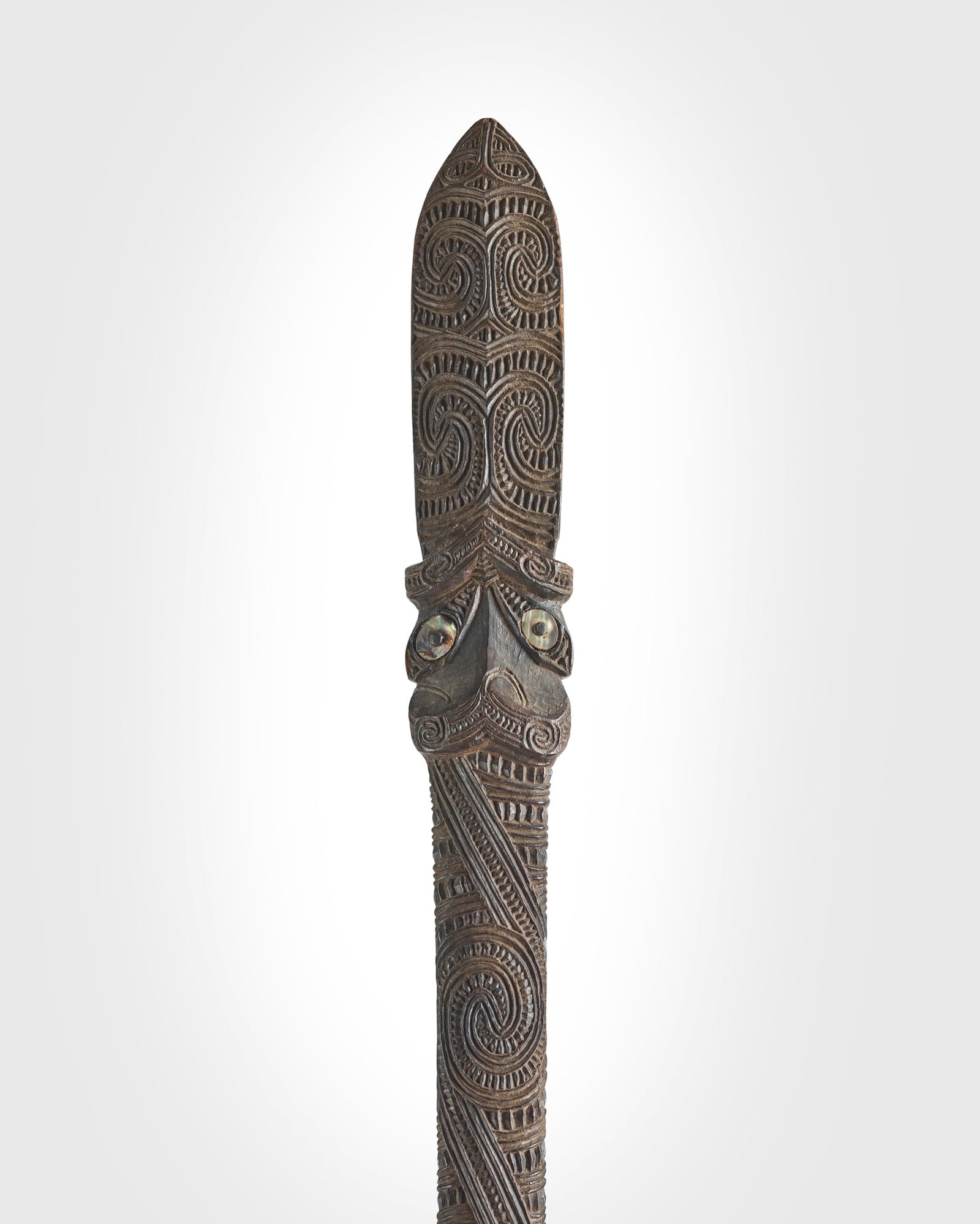 MAORI QUARTER STAFF, TAIAHA: MAORI QUARTER STAFF, TAIAHA NEW ZEALAND carved wood, wax and shell, the long tapering shaft fully covered in finely incised scrolling decoration with shell eye inlays, terminating in an upoko with fur