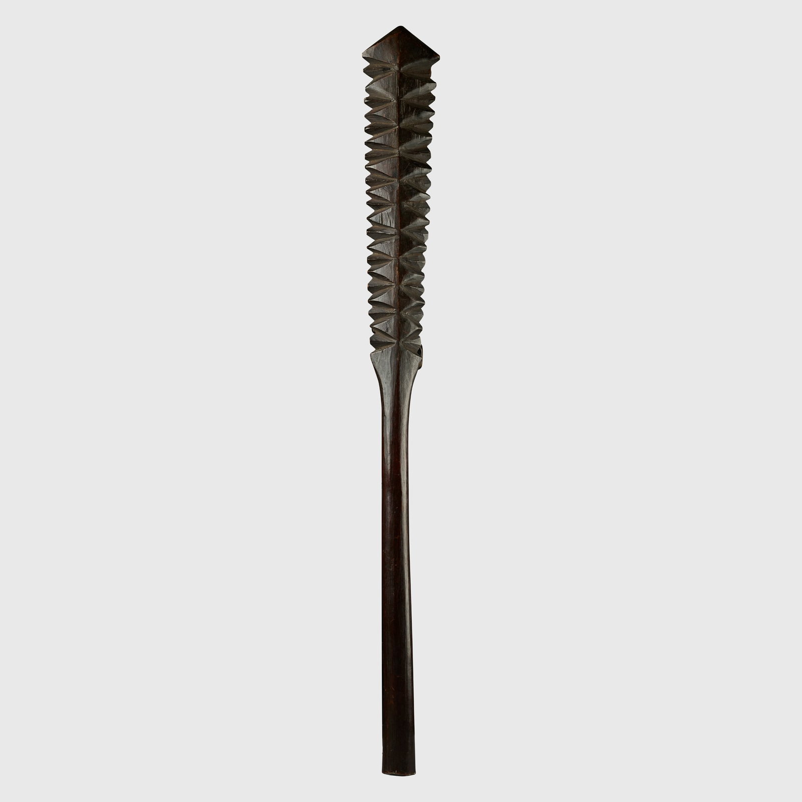 TALAVALU CLUB: TALAVALU CLUB SAMOA carved wood, the long handle leading to rows of carved teeth below a triangular head, rich patination 84.9cm long Clive Loveless, London, United KingdomPrivate collection, United K