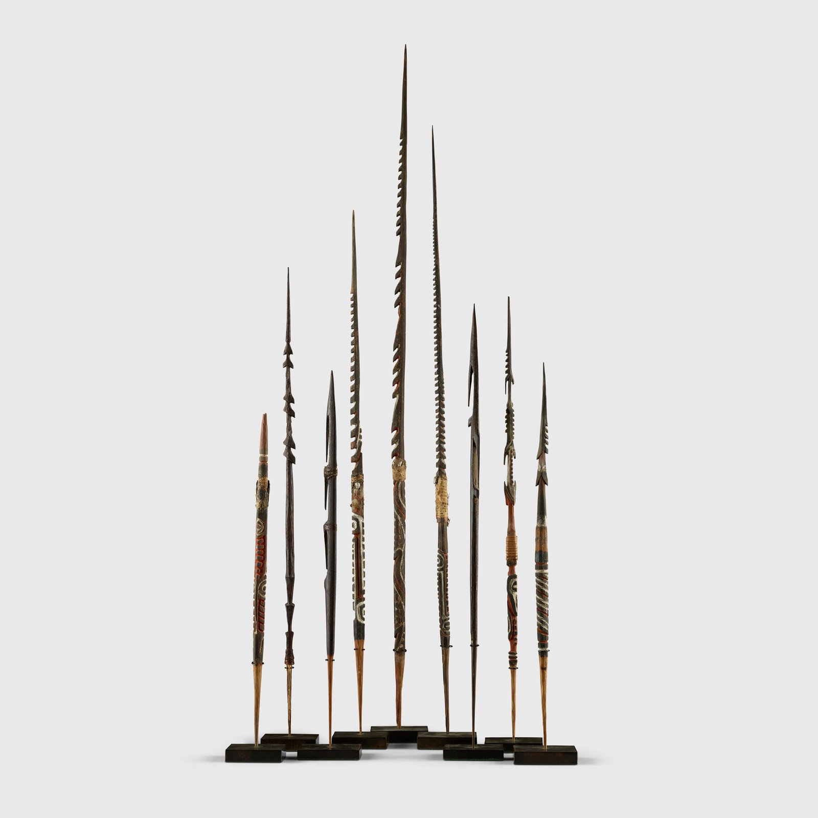 COLLECTION OF SPEARHEADS: COLLECTION OF SPEARHEADS PAPUA NEW GUINEA carved wood, pigment and shell, each raised on a bespoke mount (9) largest 39cm long Private collection, United Kingdom, acquired from the below in 2010Clive 