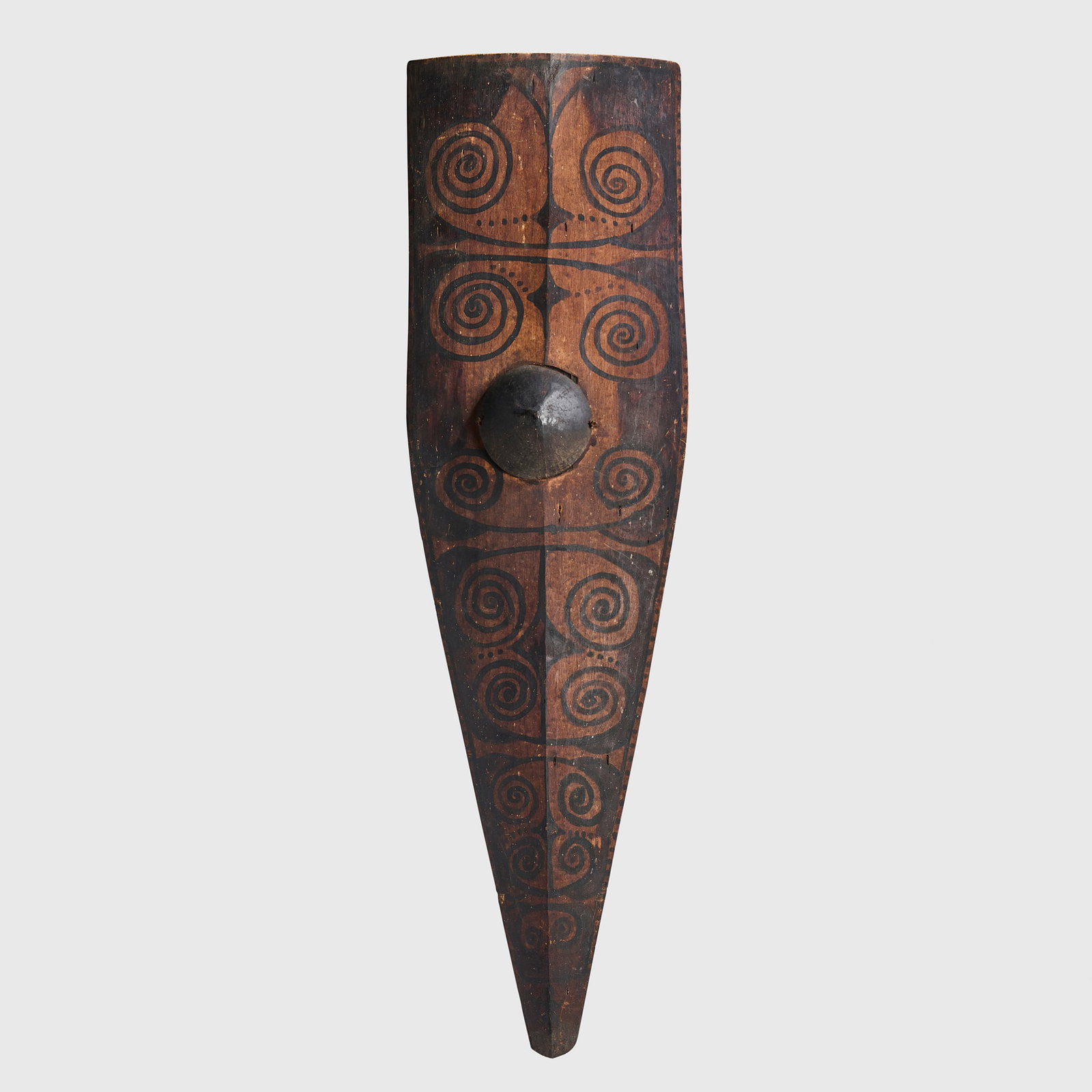 MENTAWAI KURABIT SHIELD: MENTAWAI KURABIT SHIELD WESTERN SUMATRA, INDONESIA carved wood, coconut and pigment, of elongated, tapering form, the surface decorated geometric motifs, arranged in symmetrical registers, including s