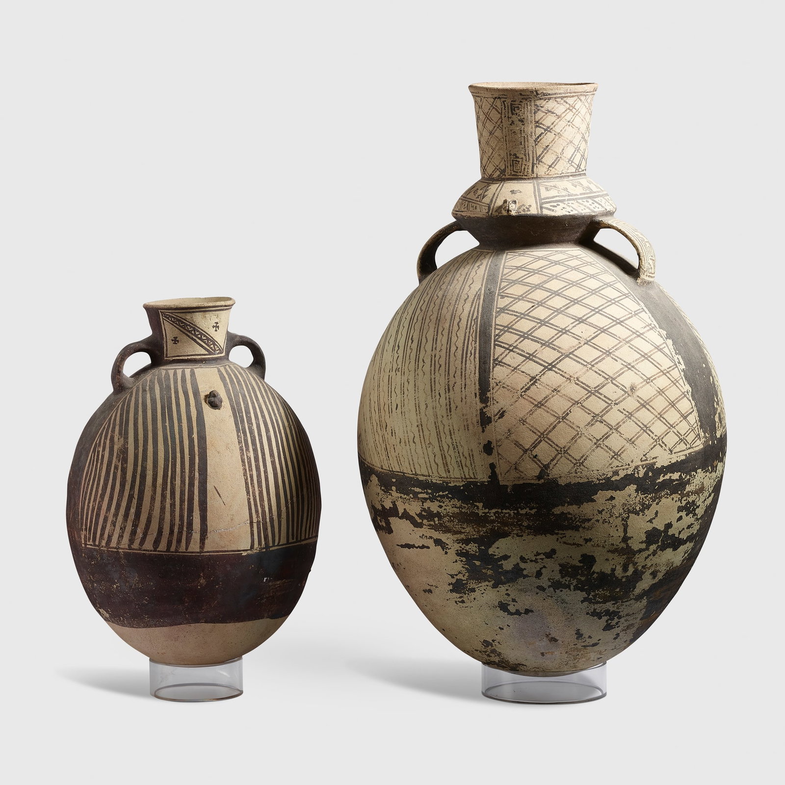 PAIR OF CHANCAY VASES: PAIR OF CHANCAY VASES SOUTHERN PERU, C. 1000 to 1470 A.D. painted terracotta, each of ovoid form and sitting on a rounded base, finished in a cream slip with umber pigment, decorated with bands and cr