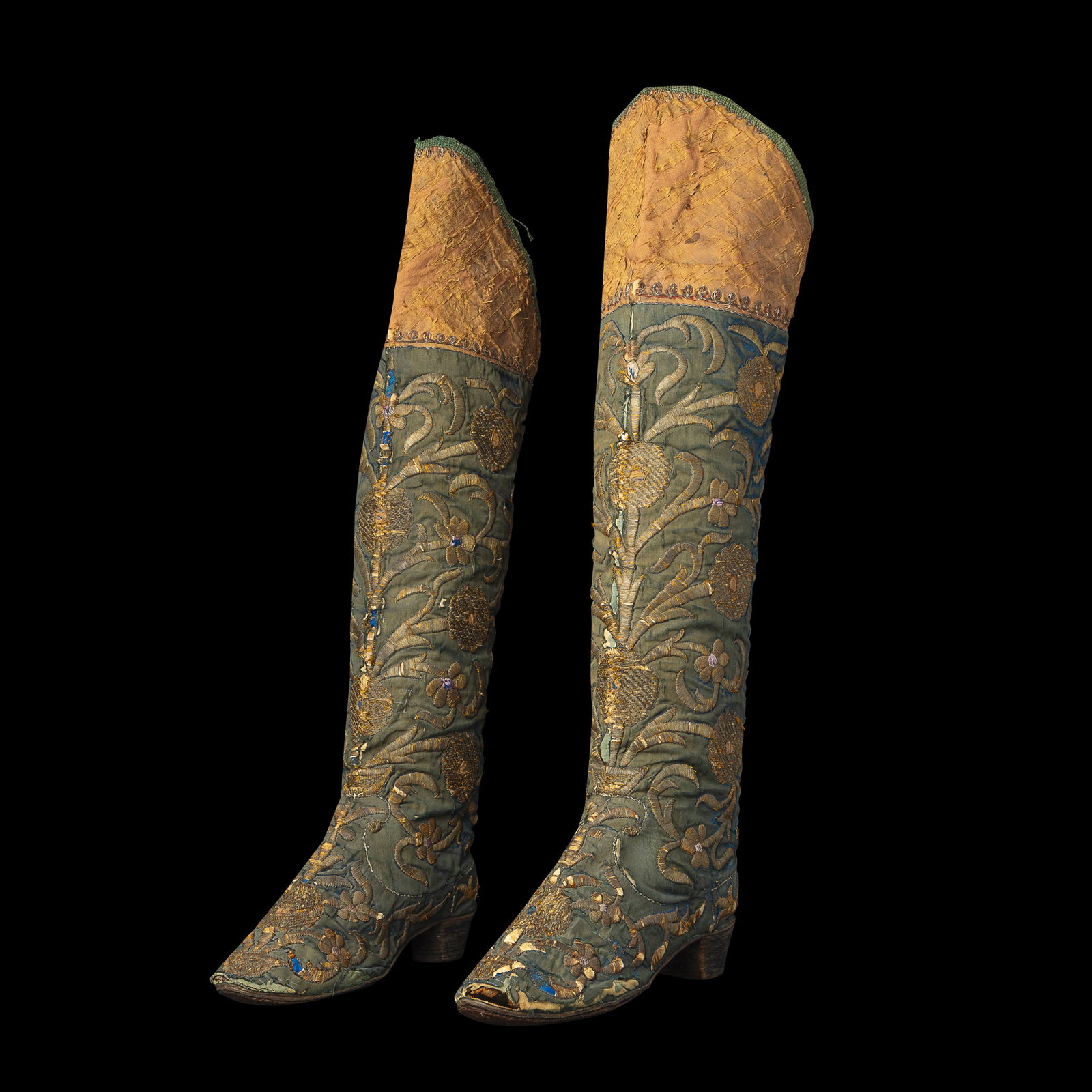 A PAIR OF OTTOMAN EMBROIDERED SILK BOOTS: A PAIR OF OTTOMAN EMBROIDERED SILK BOOTS TURKEY, LATE 18TH/ EARLY 19TH CENTURY the faint turquoise velvet ground embroidered in relief with silver thread, the decoration comprising symmetrical rococo-