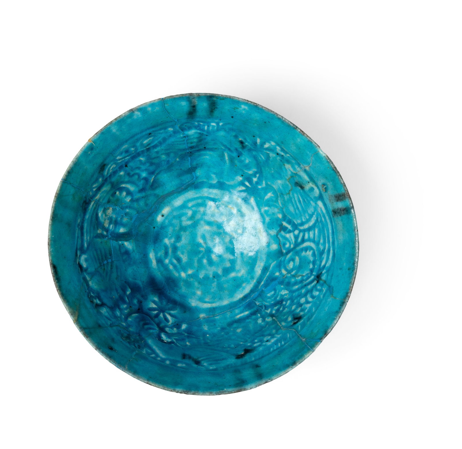 A BAMIYAN MONOCHROME TURQUOISE POTTERY BOWL: A BAMIYAN MONOCHROME TURQUOISE POTTERY BOWL AFGHANISTAN, 12TH/ 13TH CENTURY with flaring sides on a short foot, the interior incised with two extravagant facing lions, covered in a monochrome turquois